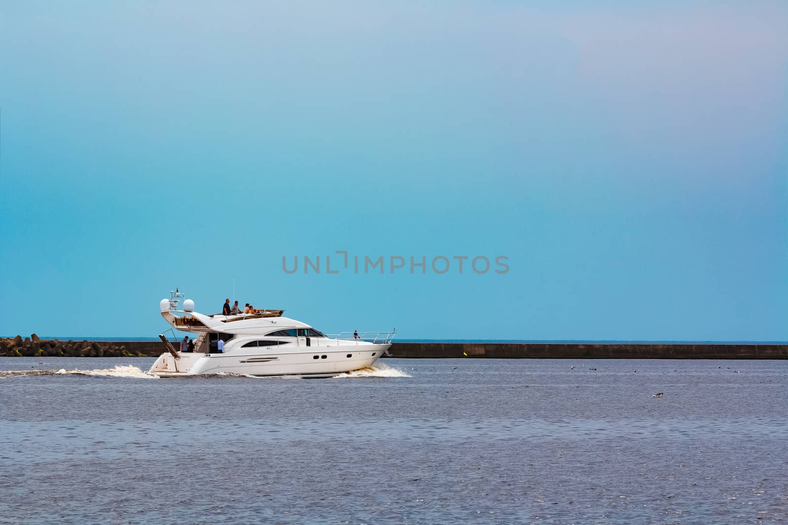 White speed boat moving fast to the Baltic sea. Water sport