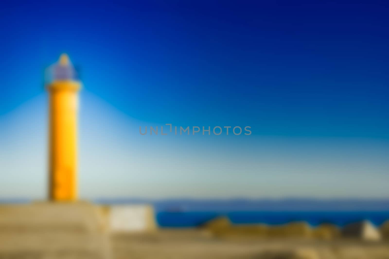 Yellow lighthouse - soft lens bokeh image. Defocused background