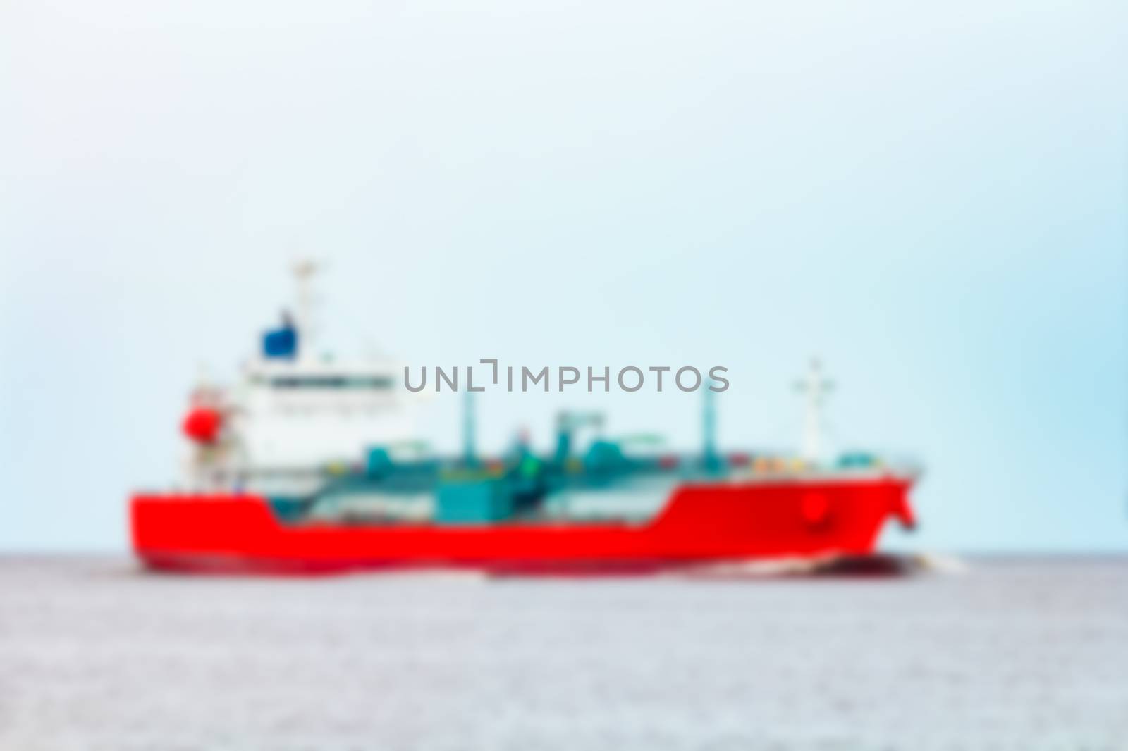 Red cargo ship - soft lens bokeh image. Defocused background