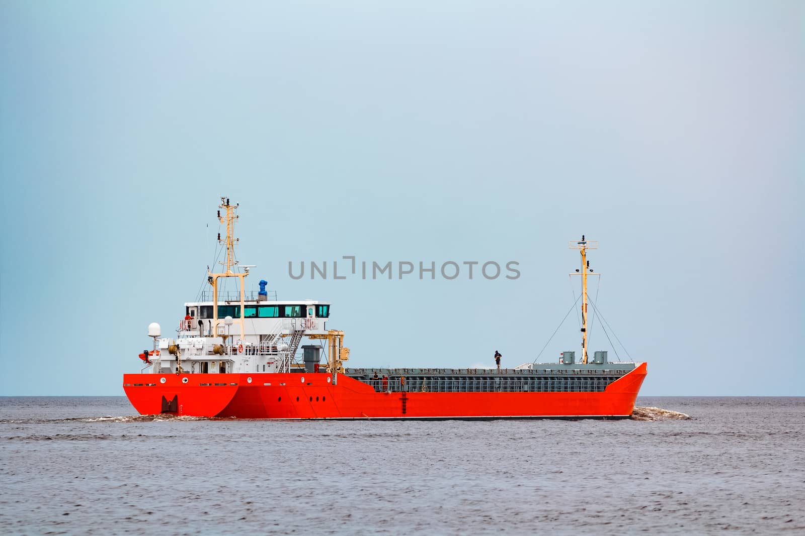 Orange cargo ship. Logistics and merchandise transportations