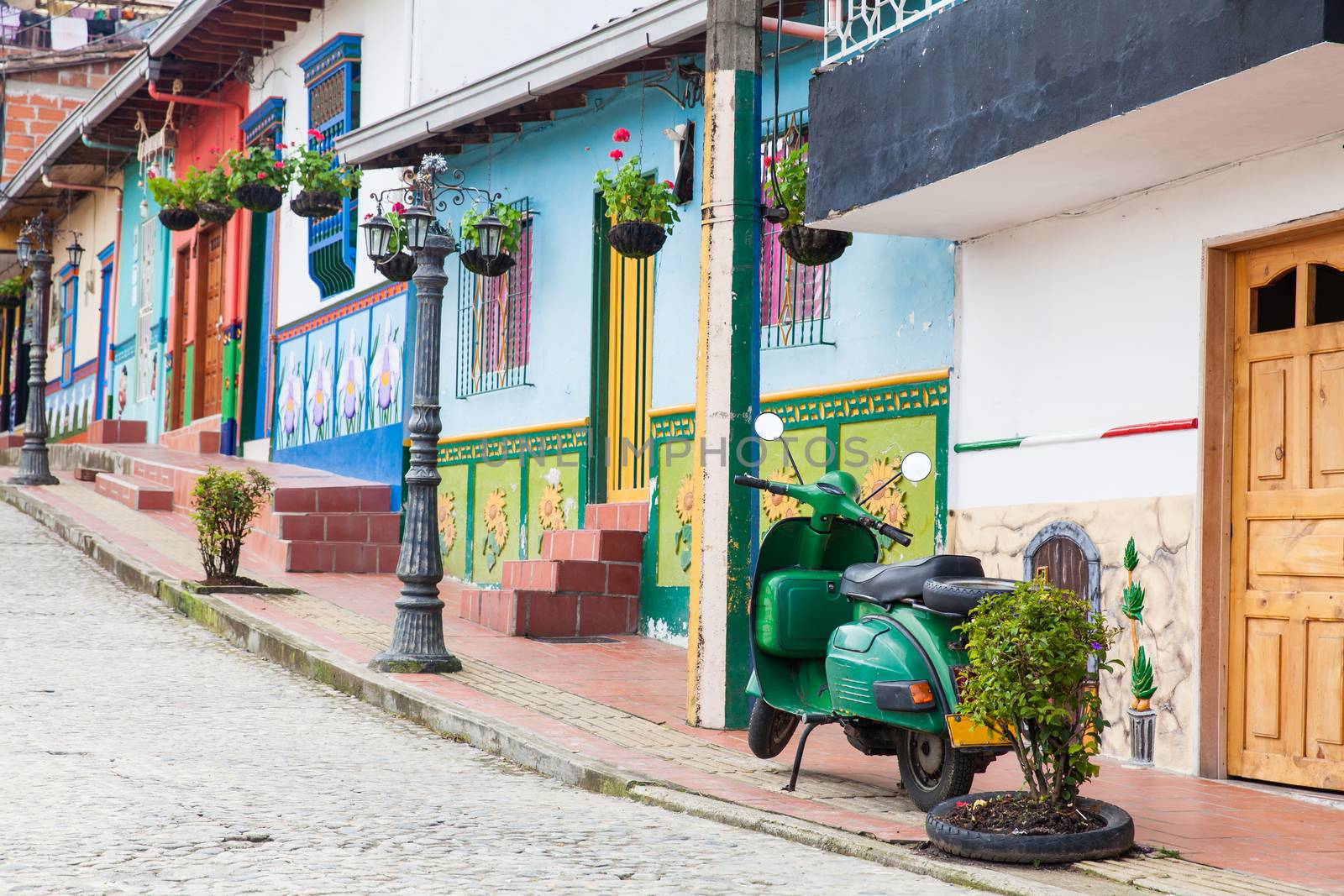 Green motorcycle at the colorful town of Guatape, Antioquia – Colombia.