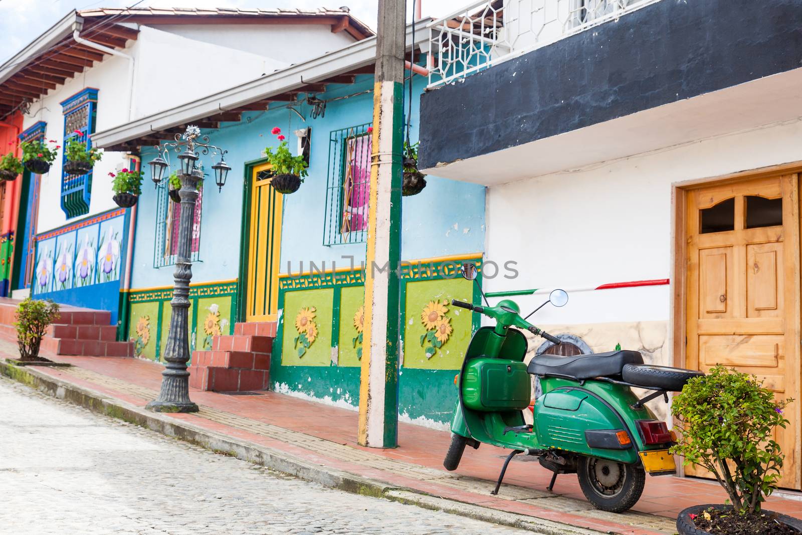 Green motorcycle at the colorful town of Guatape, Antioquia – Colombia.