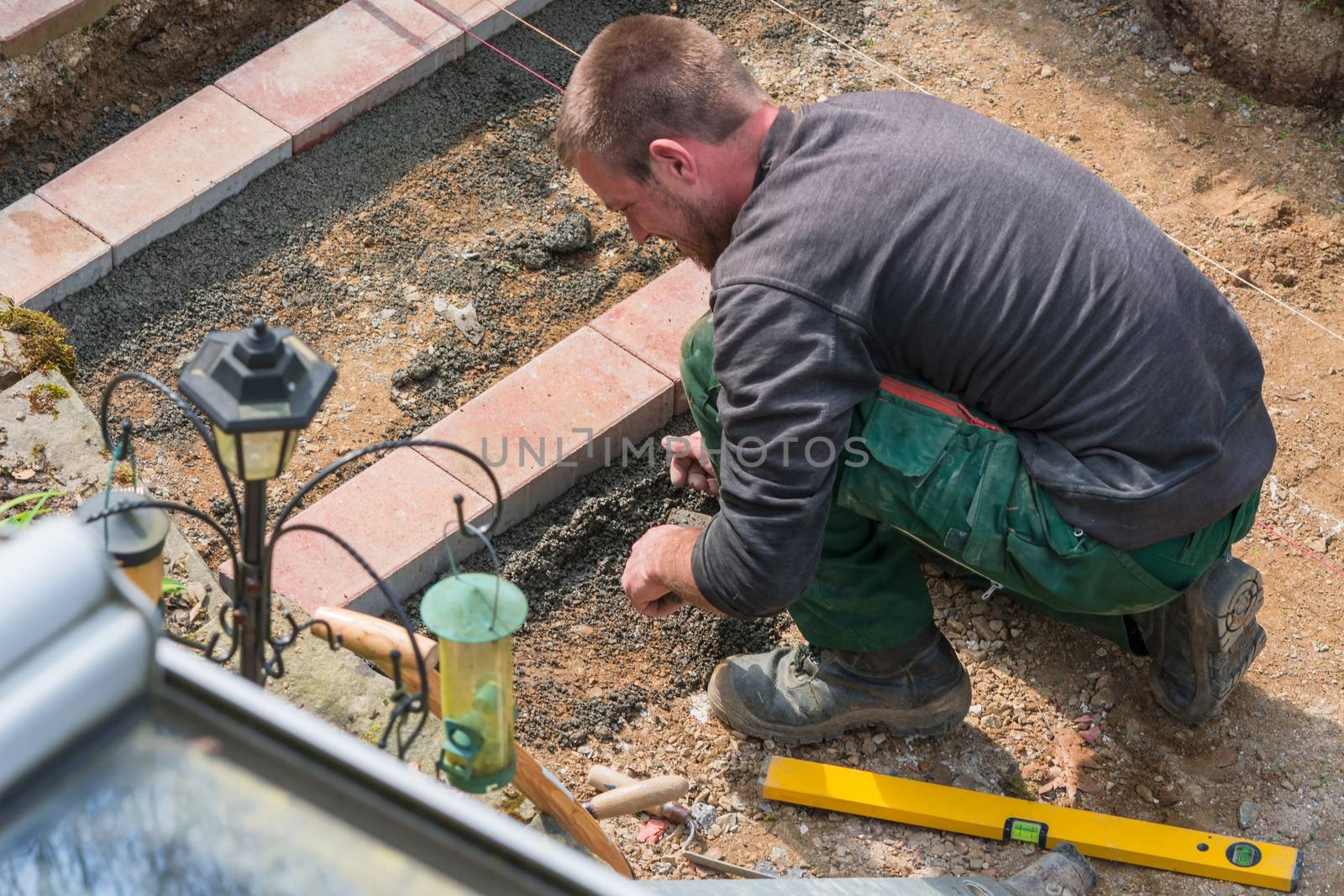 Close up, construction worker in making a bricklayer from bricks on construction site.