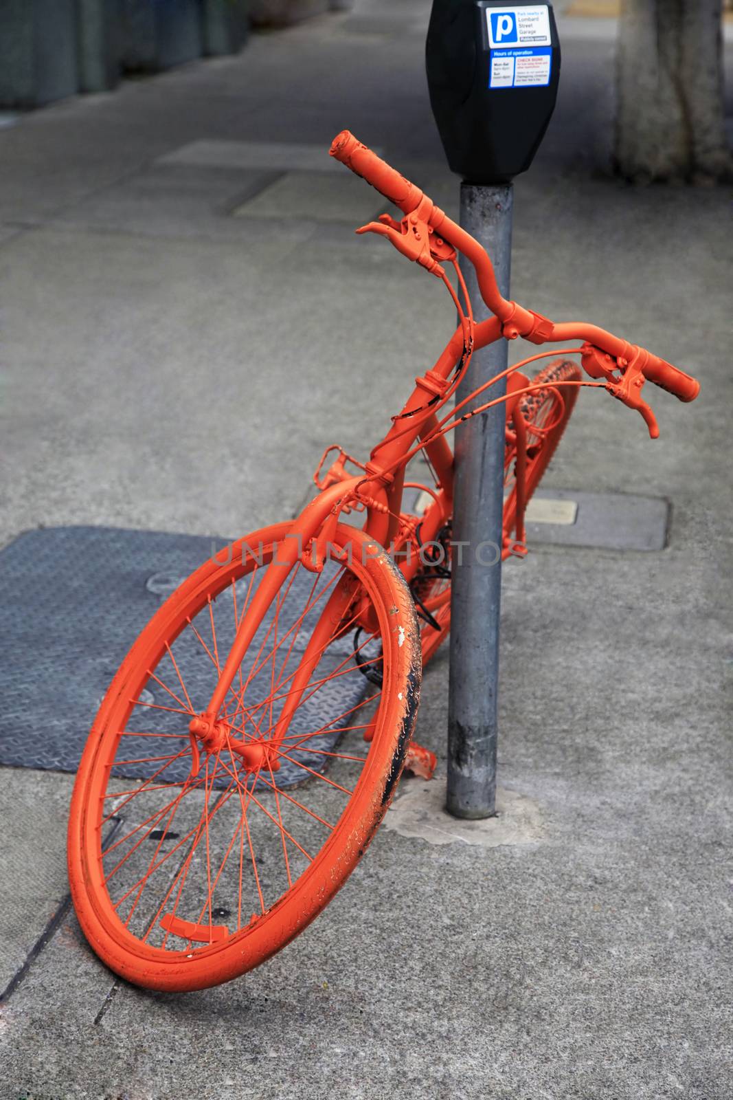 Parked orange bike by friday