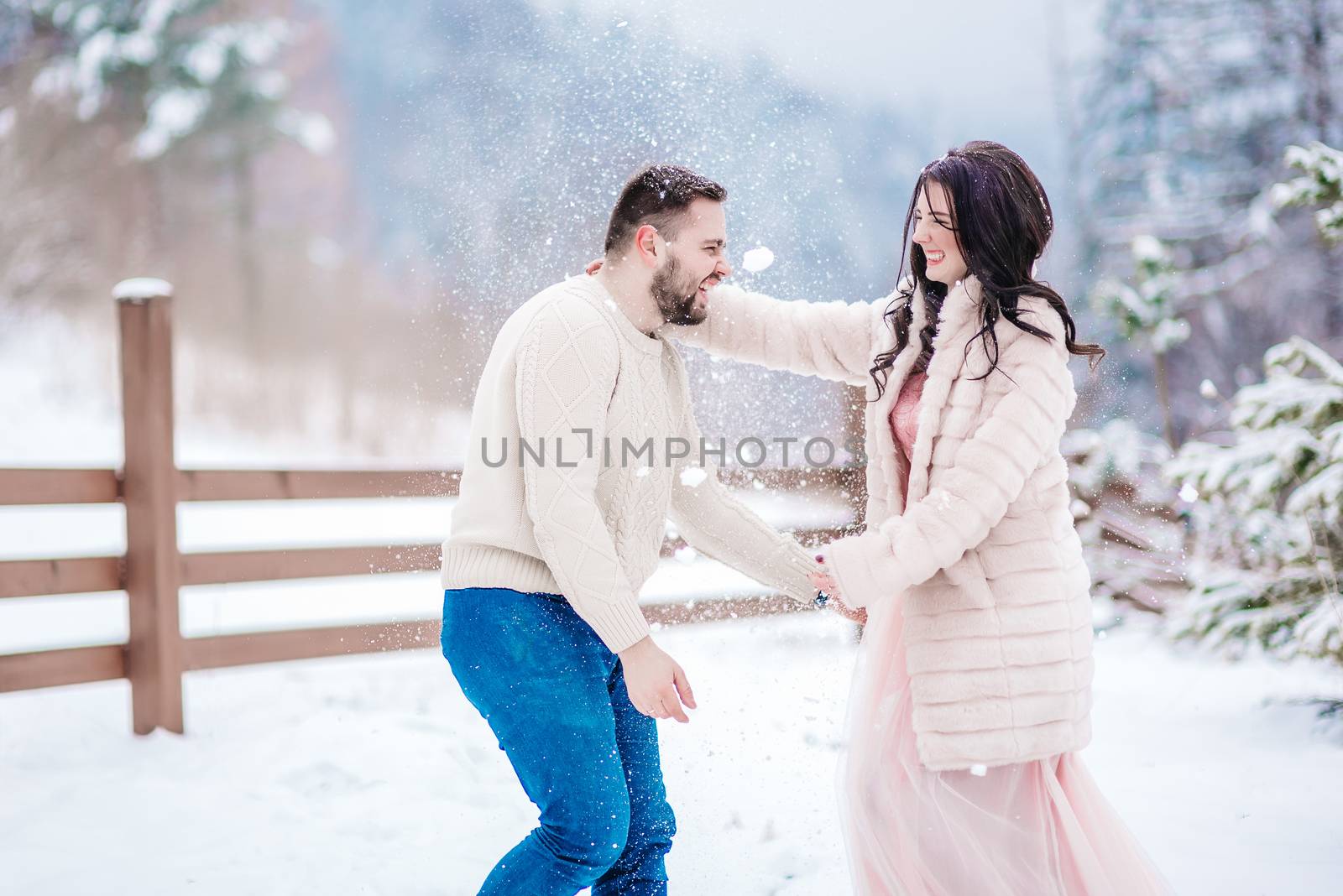 a bride in a fur coat with a fiance among the Carpathian mountains