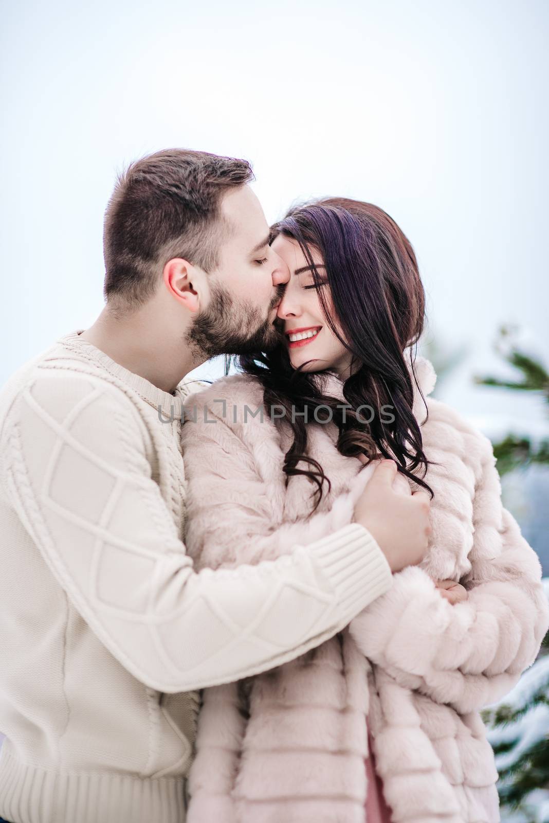 young couple on a walk in the snowy mountains by Andreua