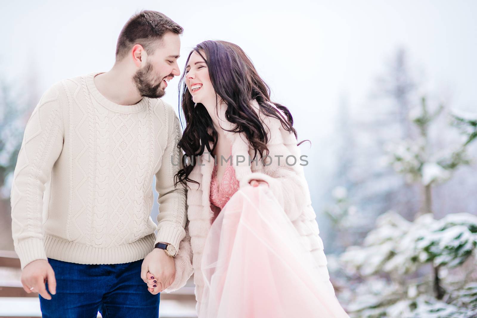 a bride in a fur coat with a fiance among the Carpathian mountains