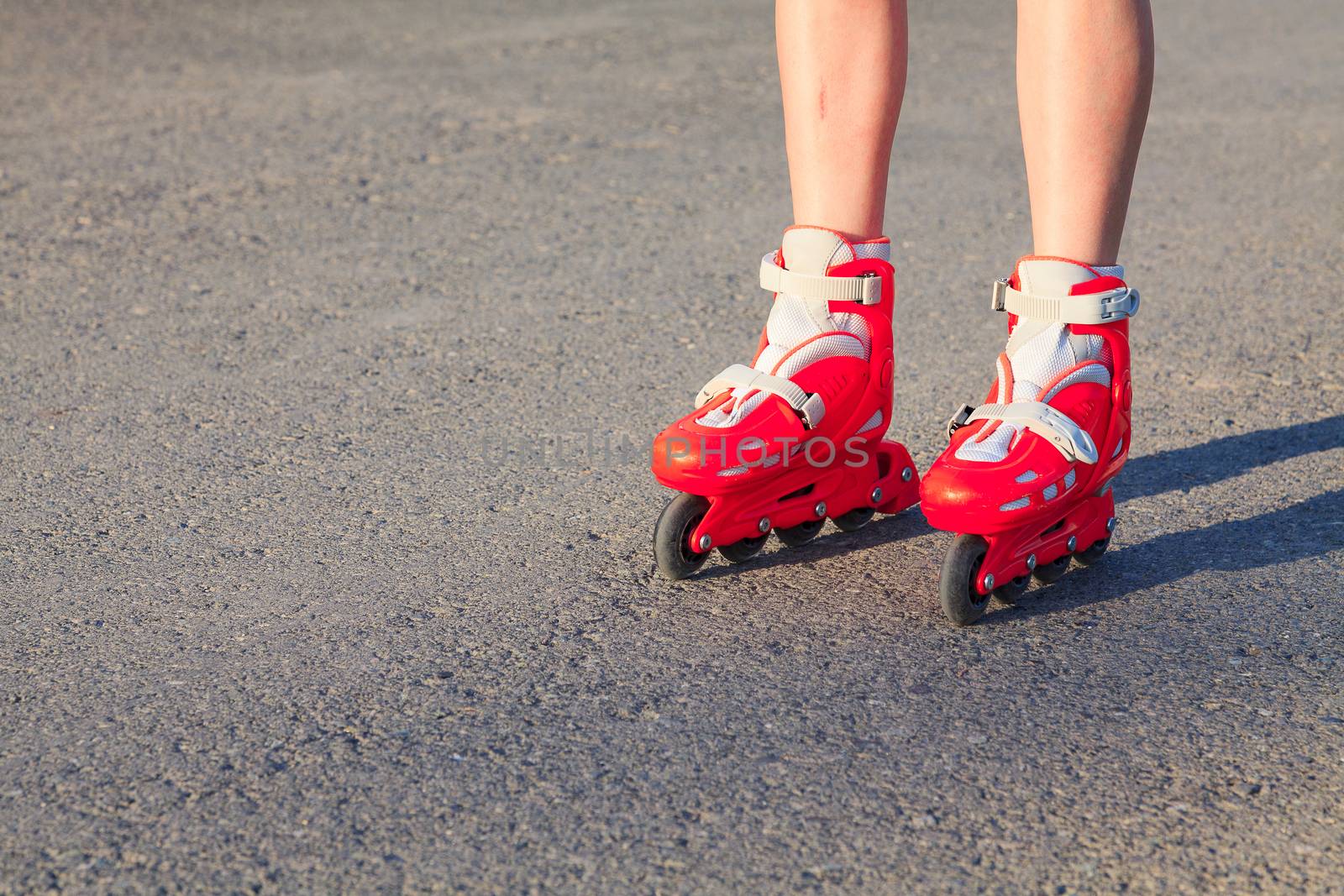 Legs of a young girl or a boy as she or he is rollerskating