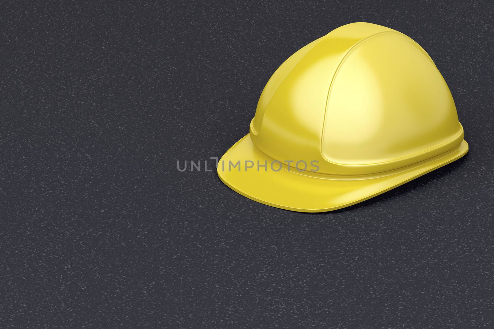 Yellow safety helmet on the asphalt