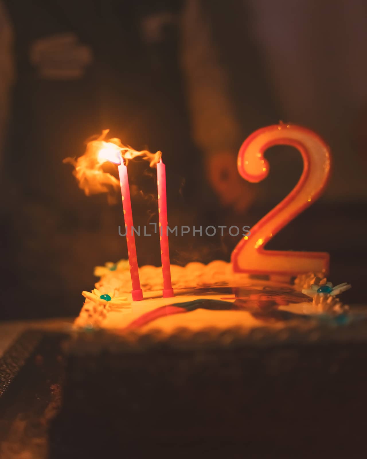 Happy birthday cake with two candles, low depht of focus for dreaming atmosphere,used split toning.