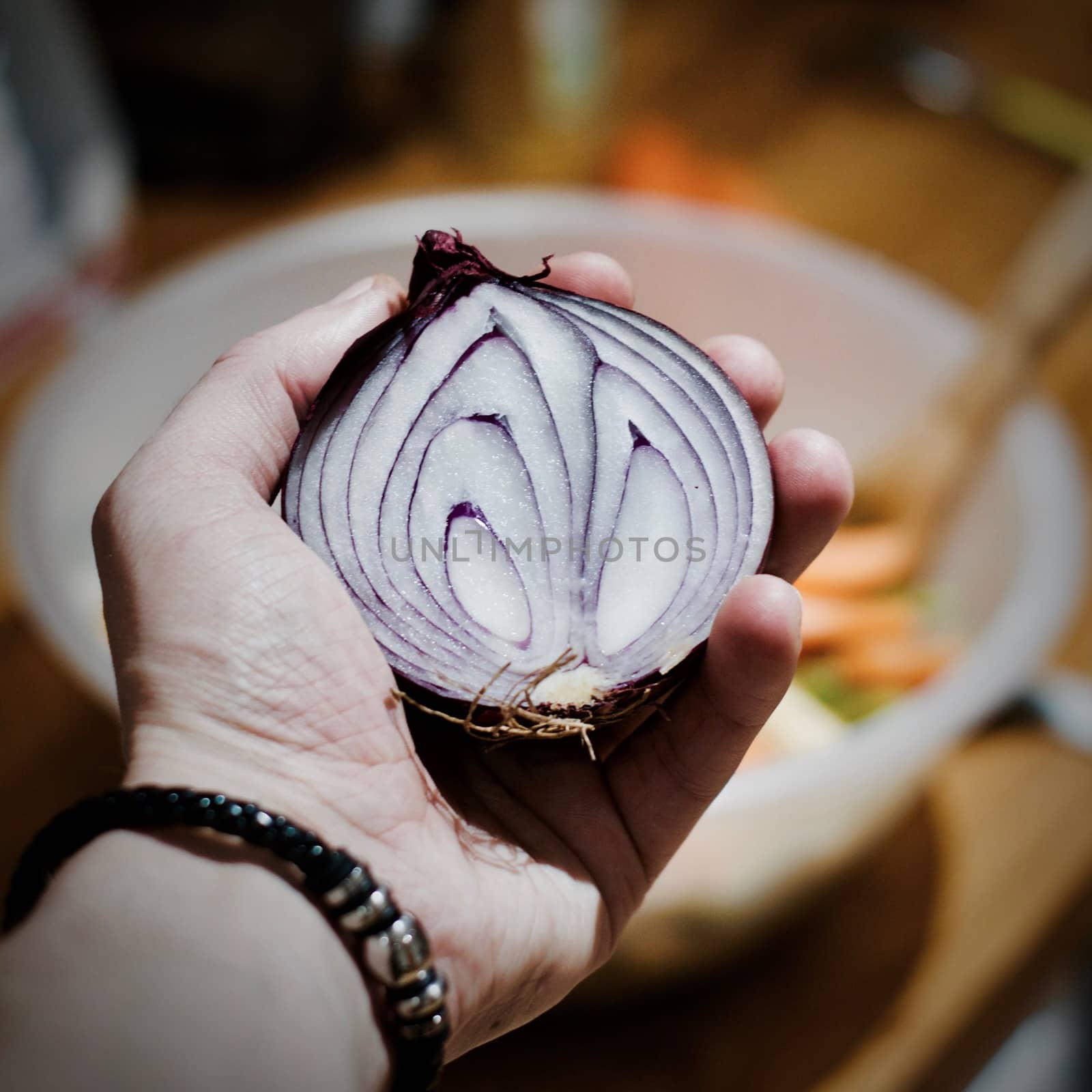 Fresh and tasty red onion in hand. Kitchen food concept.