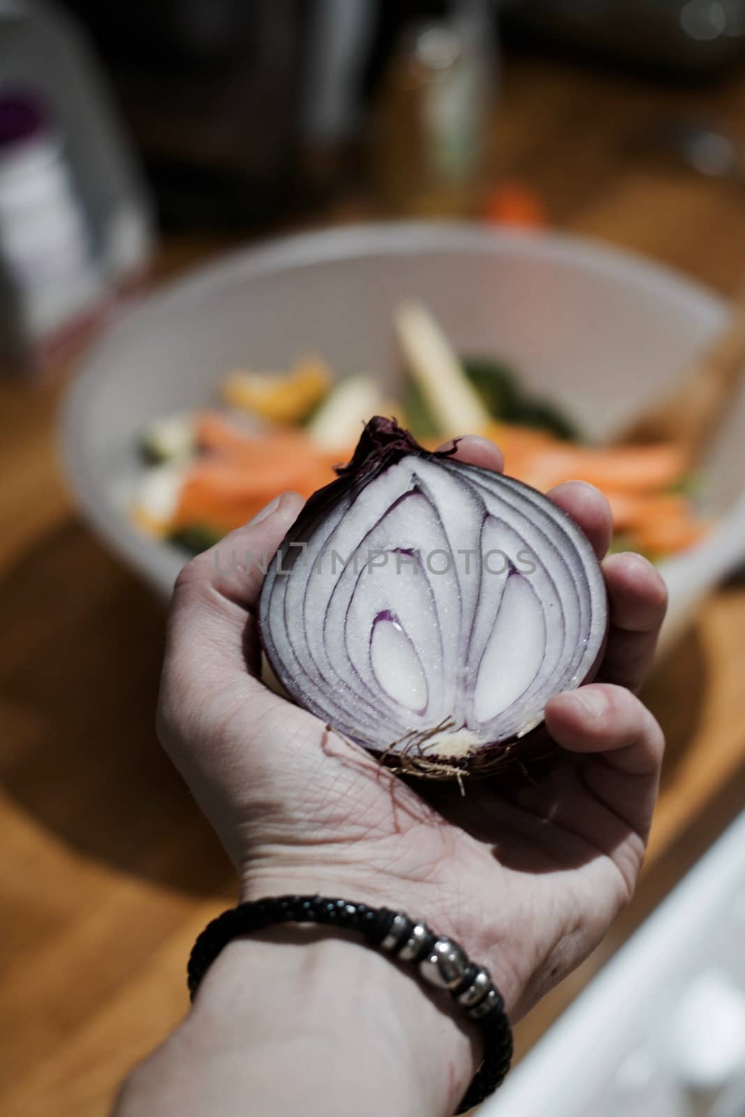 Fresh and tasty red onion in hand. Kitchen food concept.