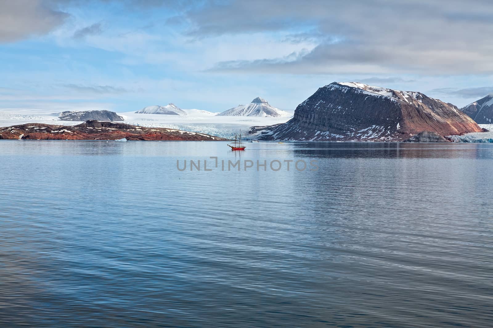 Glacier and mountains in Svalbard islands and sailing ship, Norway