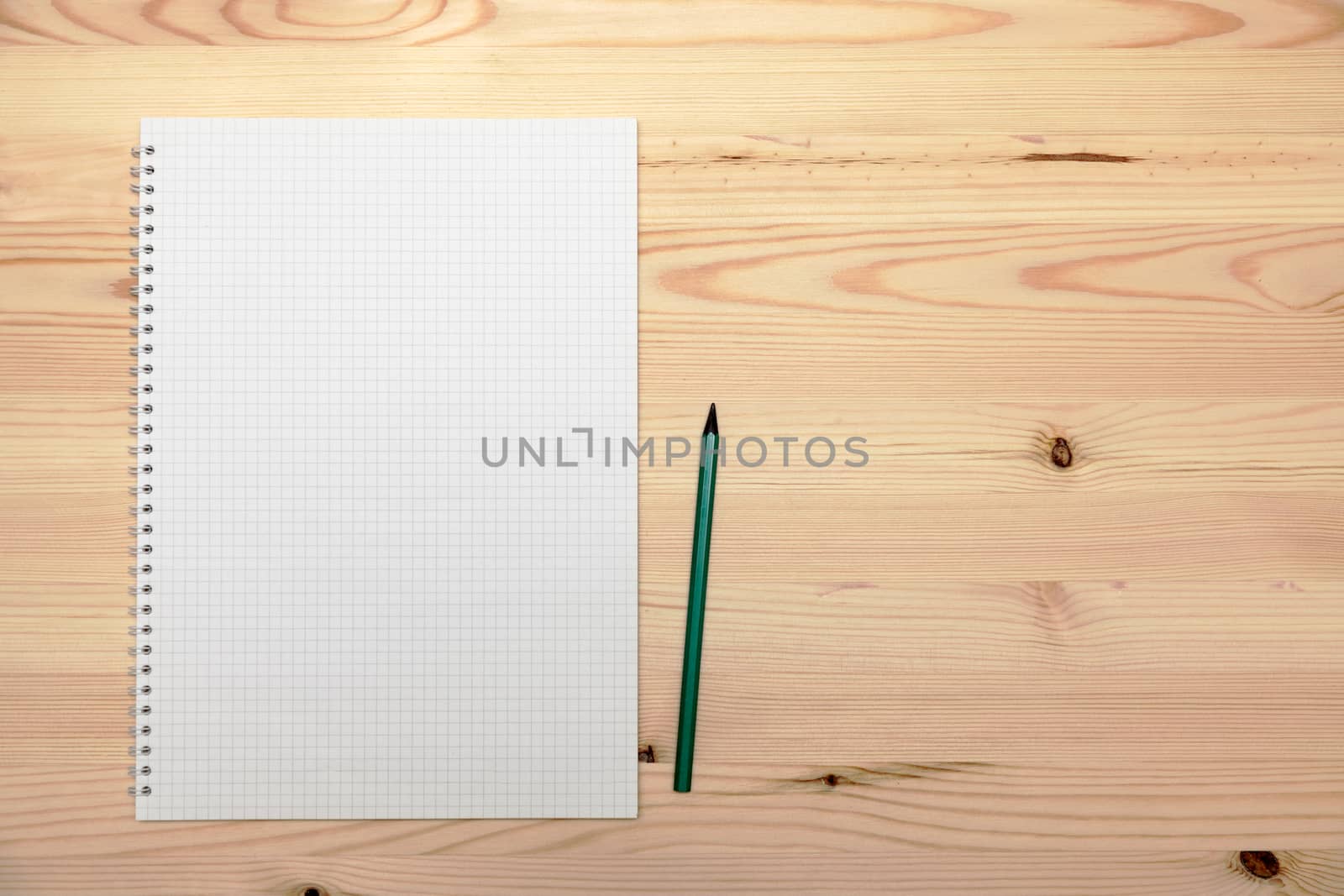 Notepad (copybook) with spiral and pencil on light wooden table, by Nobilior