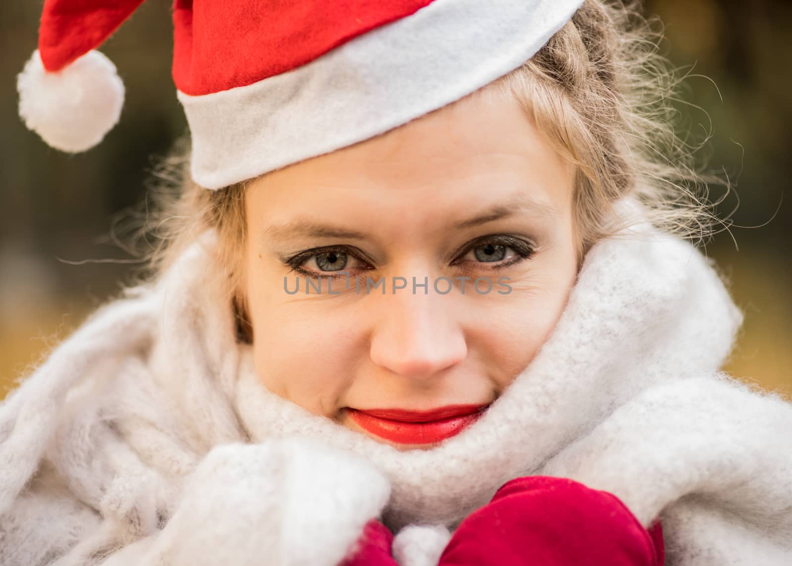 european woman wearing christmas hat,red mittens and soft clothes. christmas concept