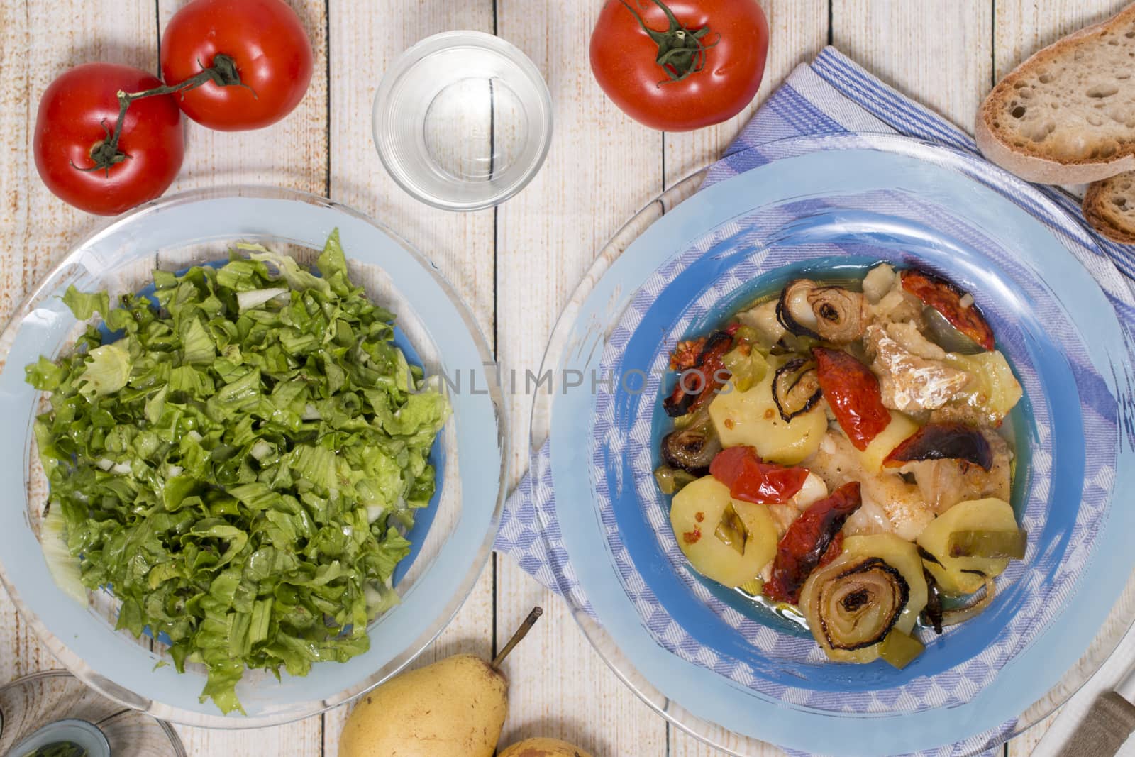Traditional portuguese meal done in the oven, codfish with potatoes in olive oil.