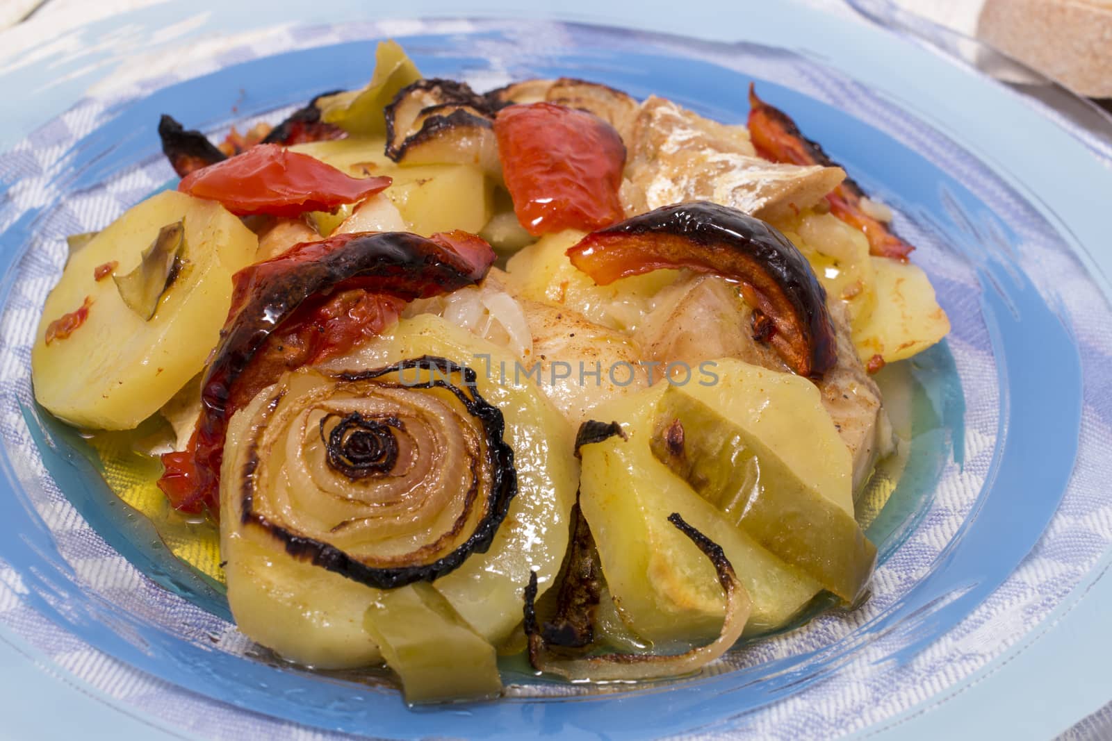 Traditional portuguese meal done in the oven, codfish with potatoes in olive oil.