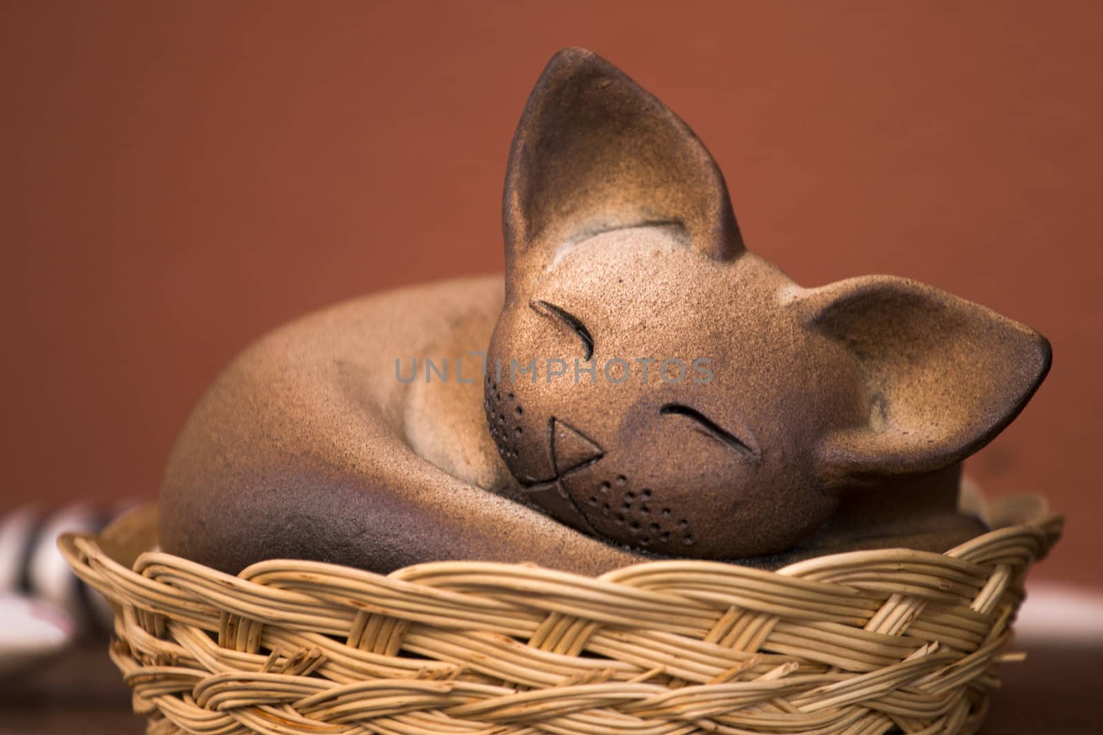 Beautiful souvenir sleeping cat from Monchique village, Portugal.