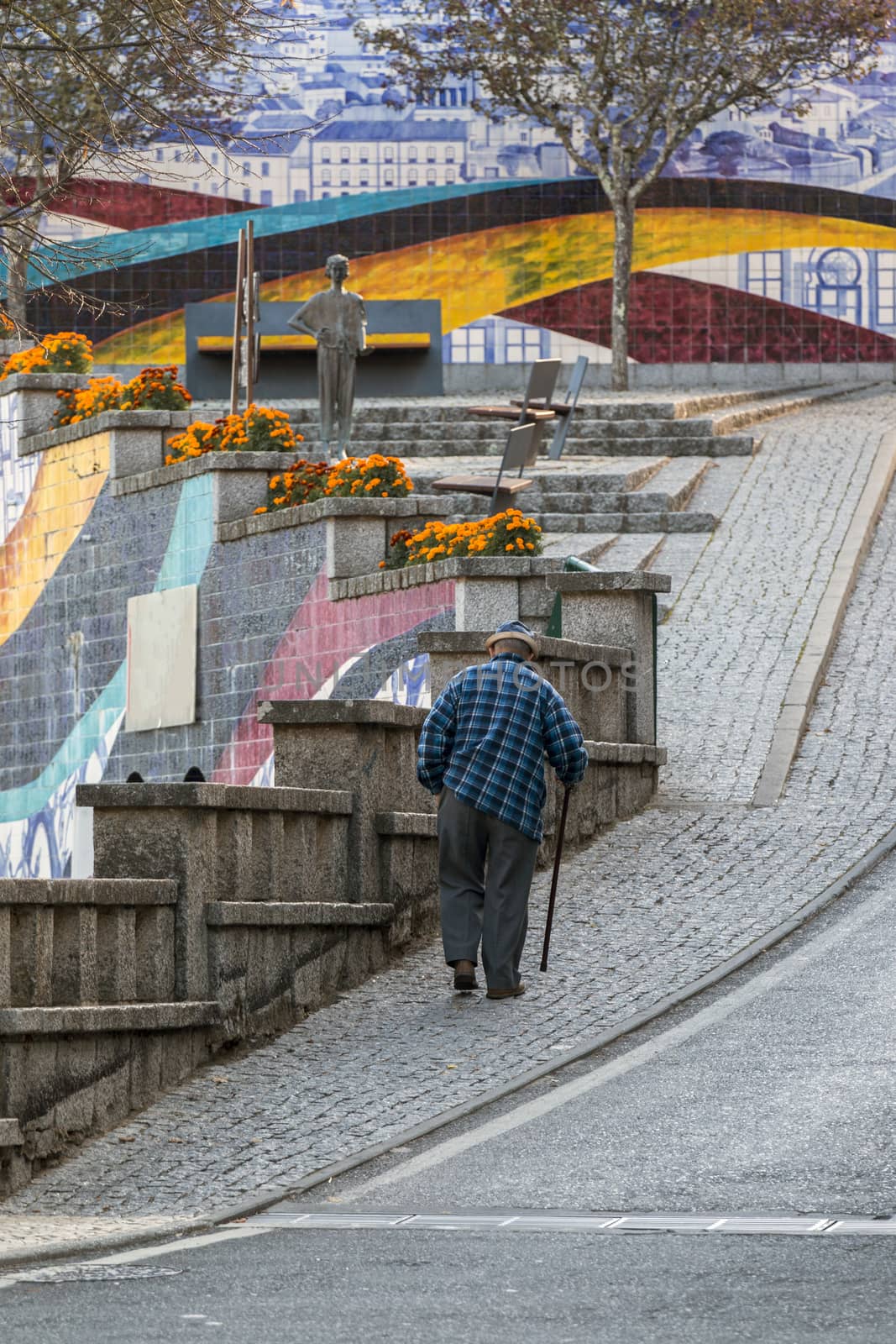 Old man walking in the streets  of Monchique village, Portugal.
