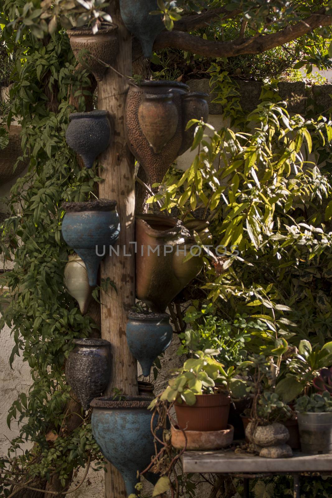 Curious ceramic flower pots on a garden.