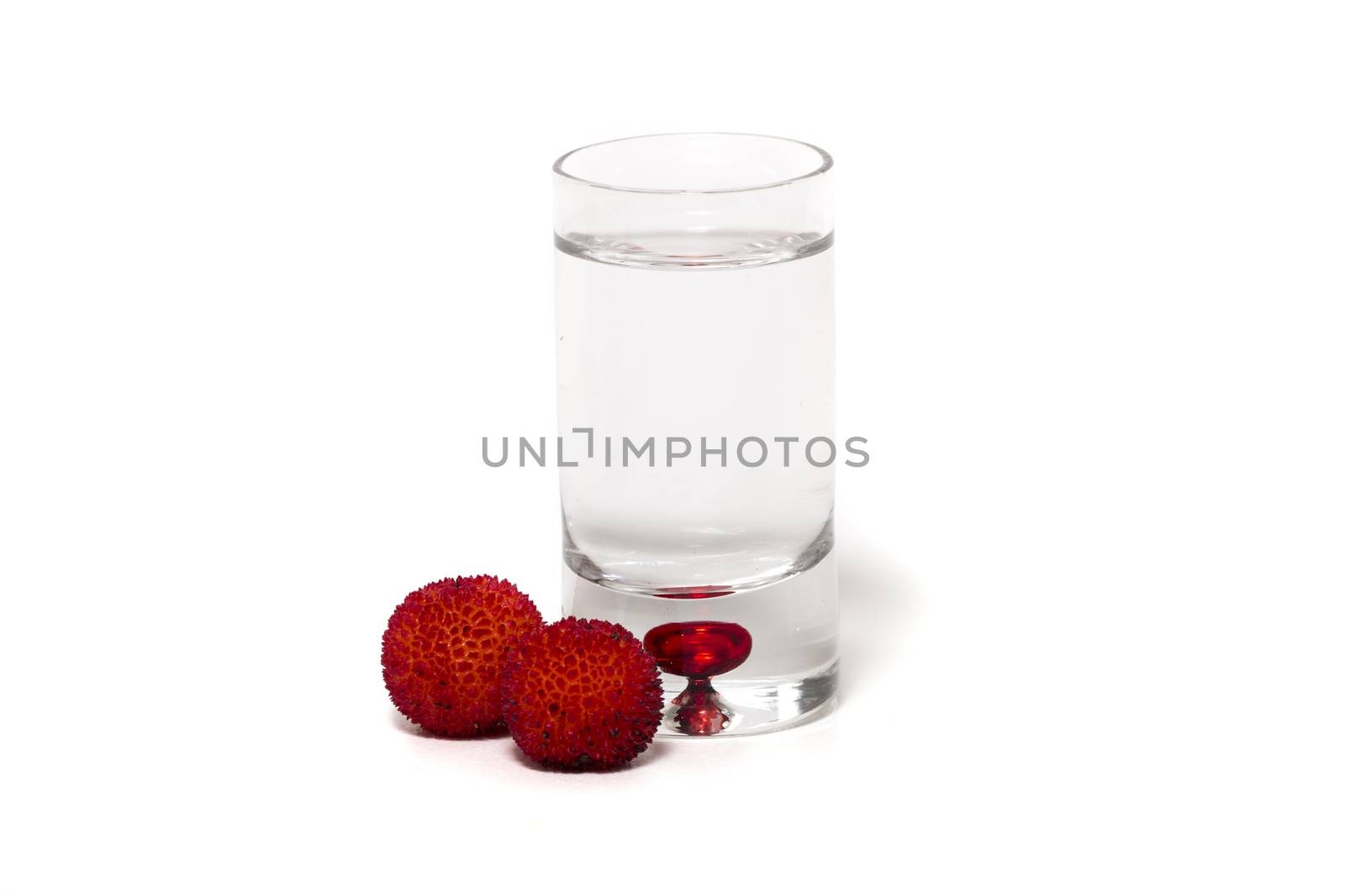 Close up view of strawberry tree (Arbutus Unedo) fruit with aguardiente isolated in white background.