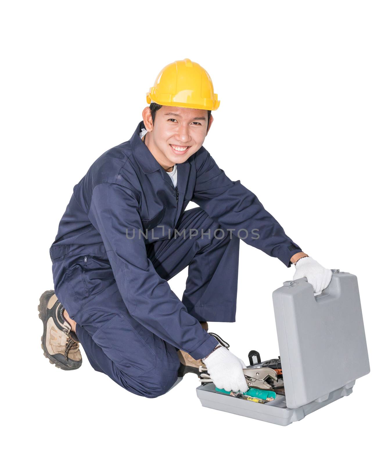 Young handyman sitting with his tool box isolated on white background