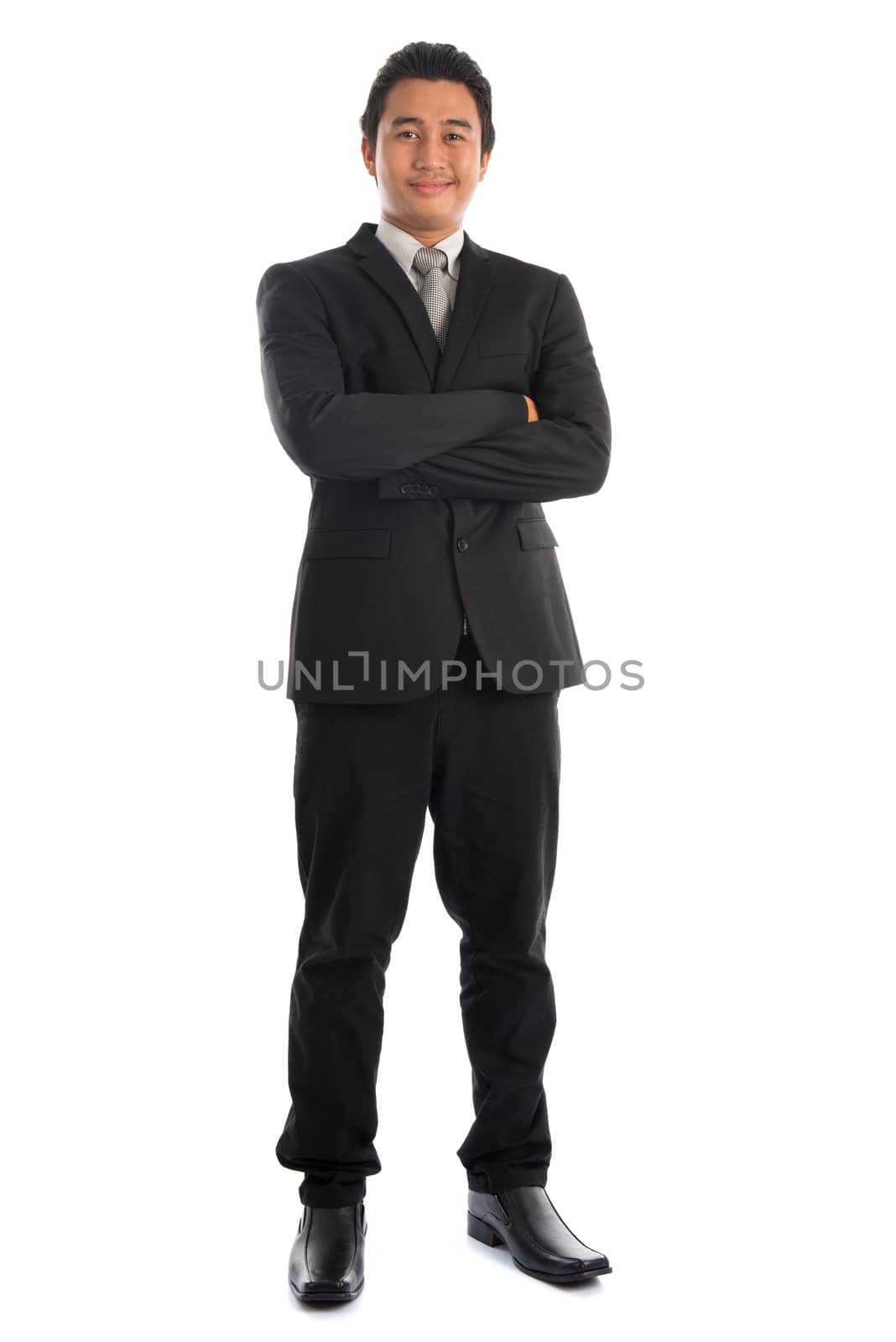 Full body attractive young Southeast Asian businessman arms crossed standing isolated on white background. Asian malay male model.
