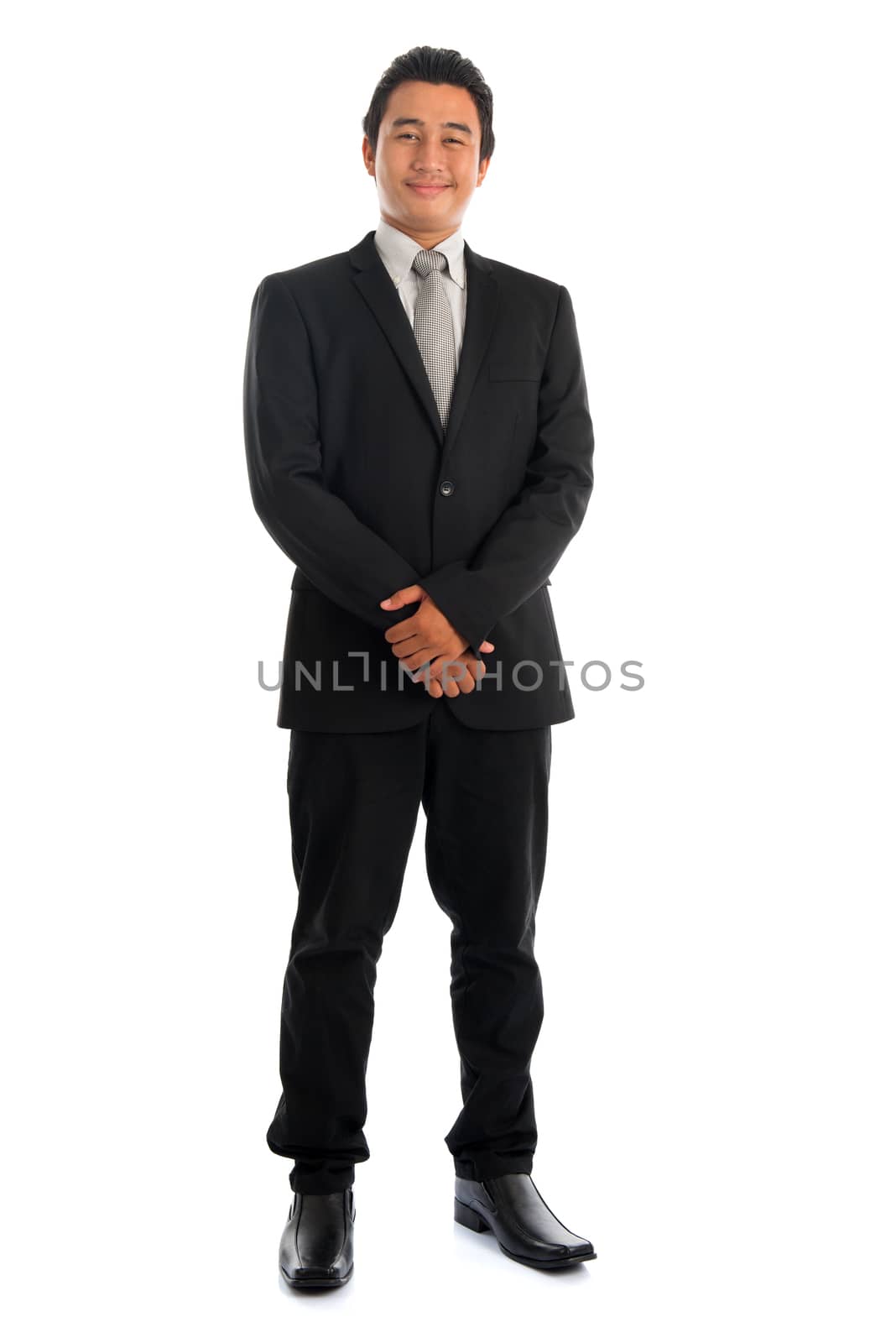 Full body confident young Southeast Asian businessman standing isolated on white background. Asian malay male model.