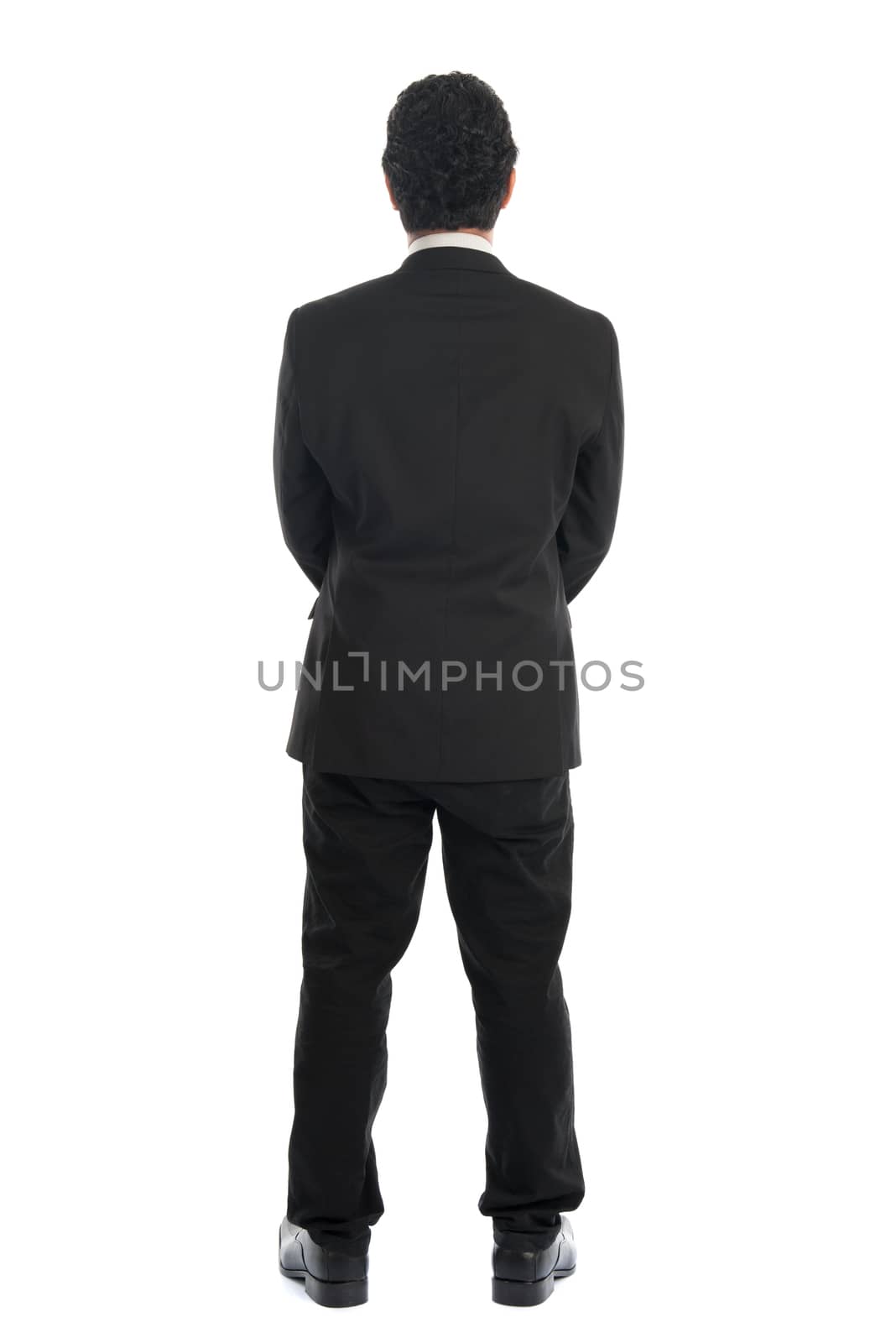 Full body back view of young Southeast Asian businessman standing isolated on white background. 
