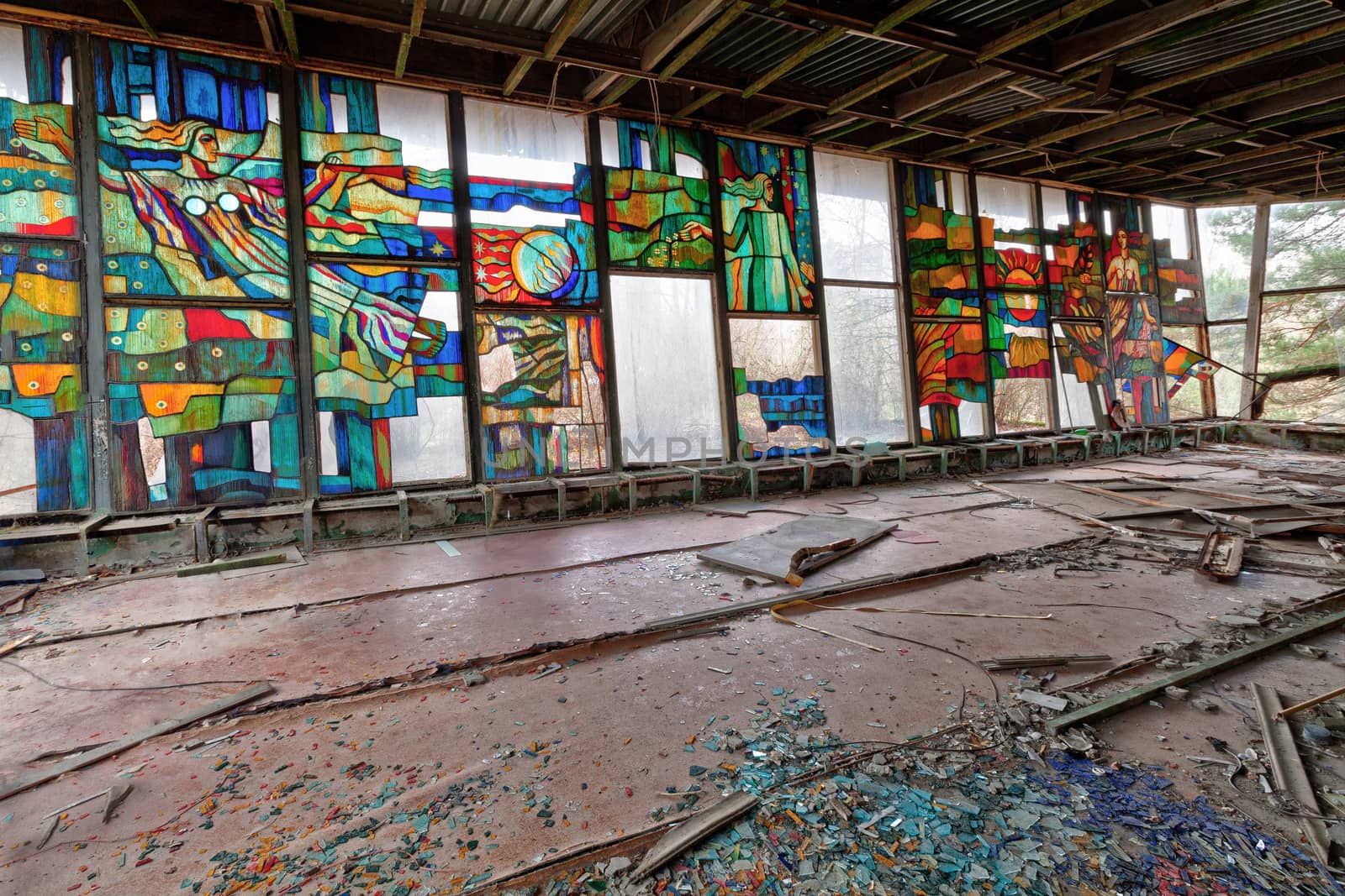 Stained glass inside of abandoned and ruined building of river port in overgrown ghost city Pripyat. by igor_stramyk