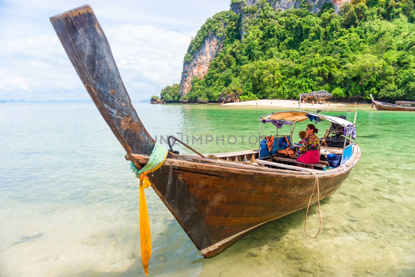 tourists on a sea walk on a traditional Thai boat long tail in T by kosmsos111