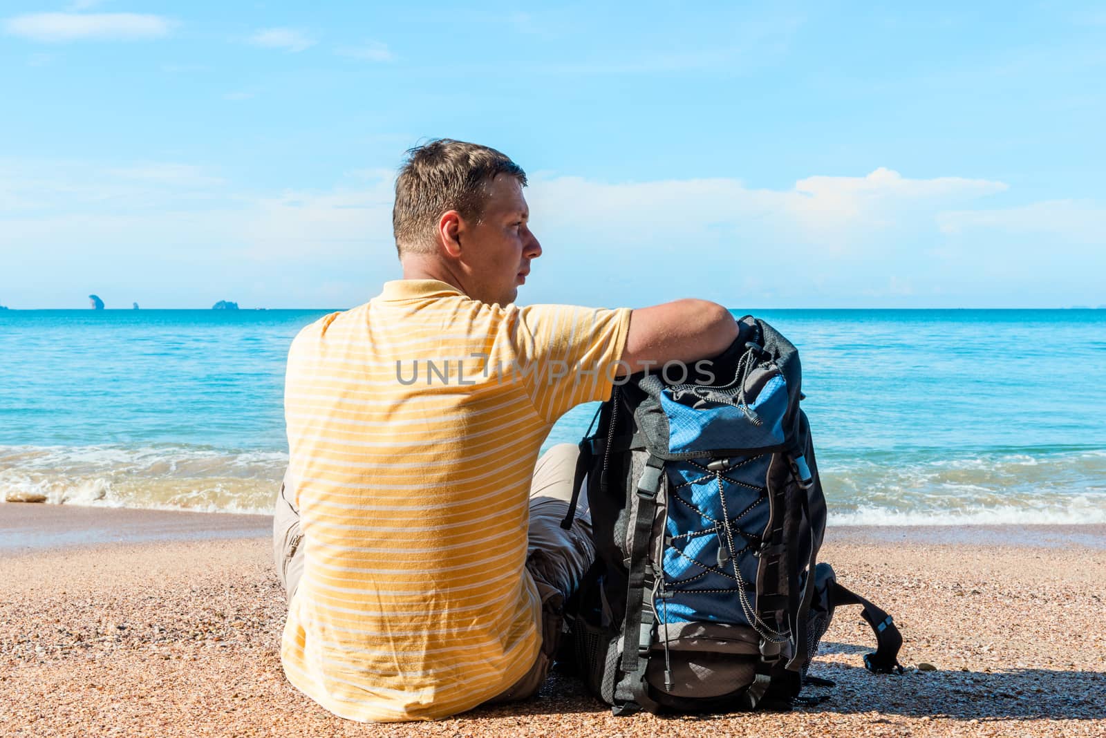 tourist on vacation at sea, a man with a backpack in a hike on a halt