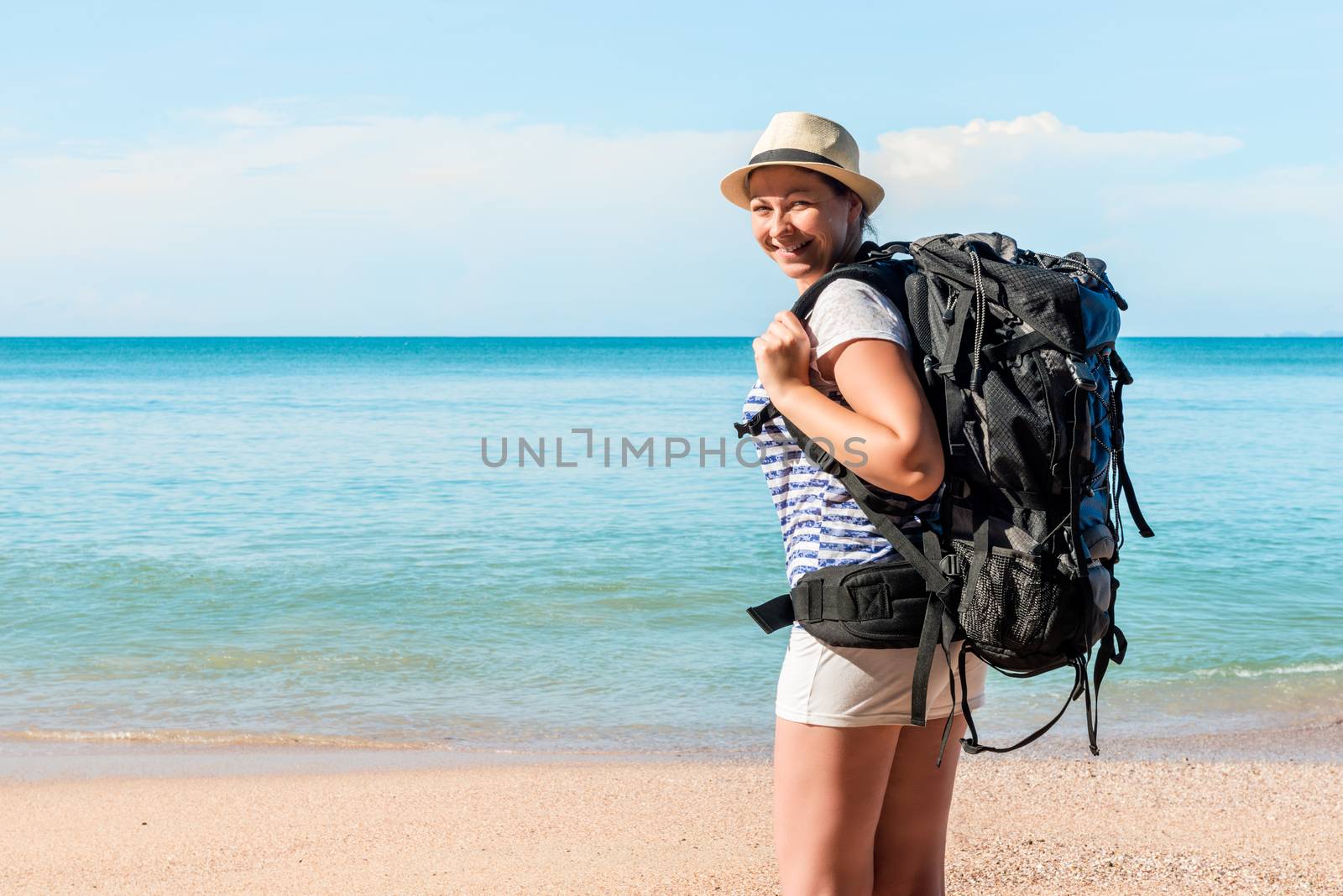 happy woman tourist on the beach on vacation