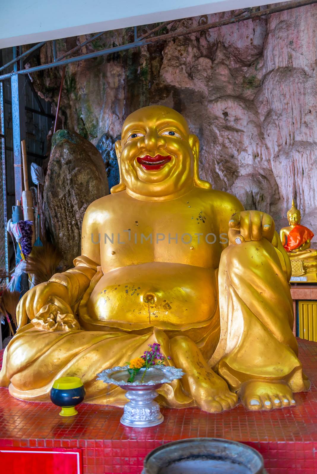 golden sculpture of a fat deity in the temple of Thailand