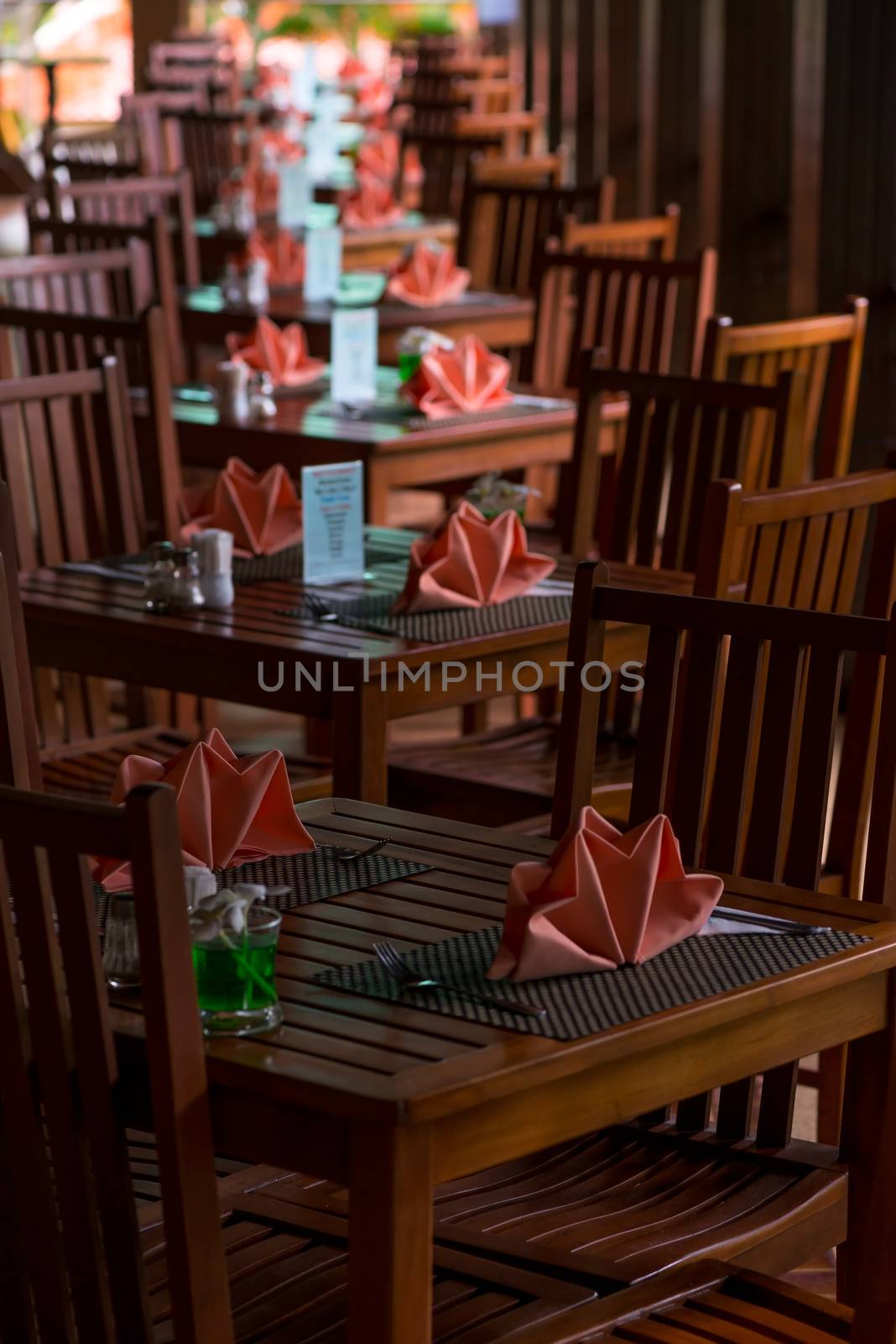 rows of café tables on the veranda with nice napkins there are by kosmsos111