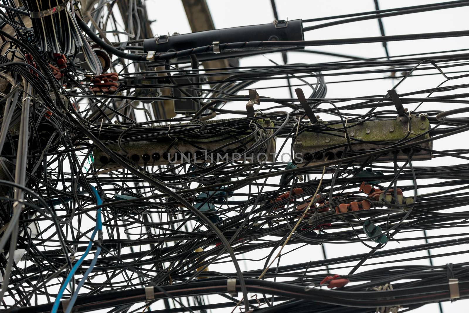 randomly hanging wires on electrical poles in Thailand closeup