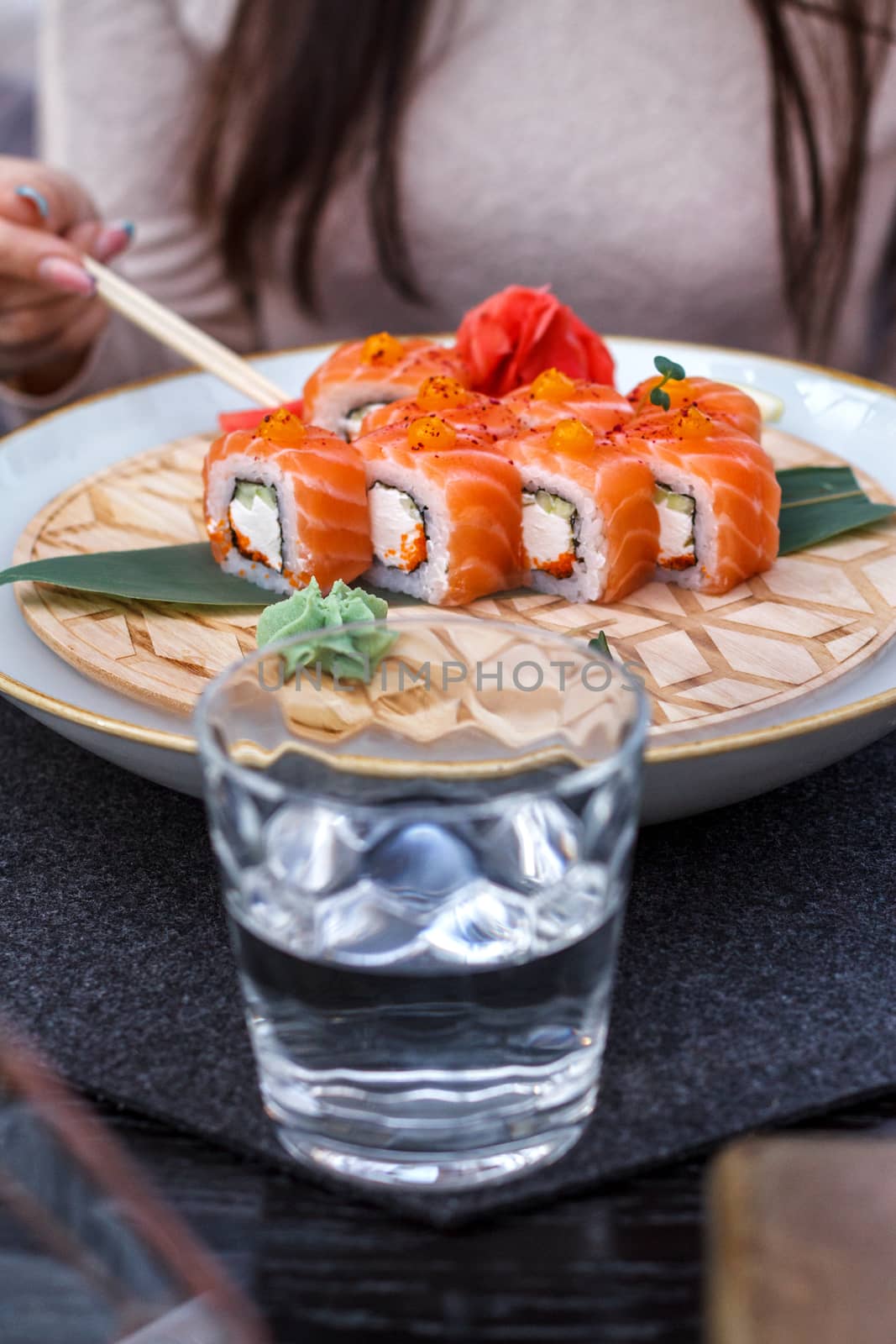 Fresh sushi on a platter is cooled with ice.