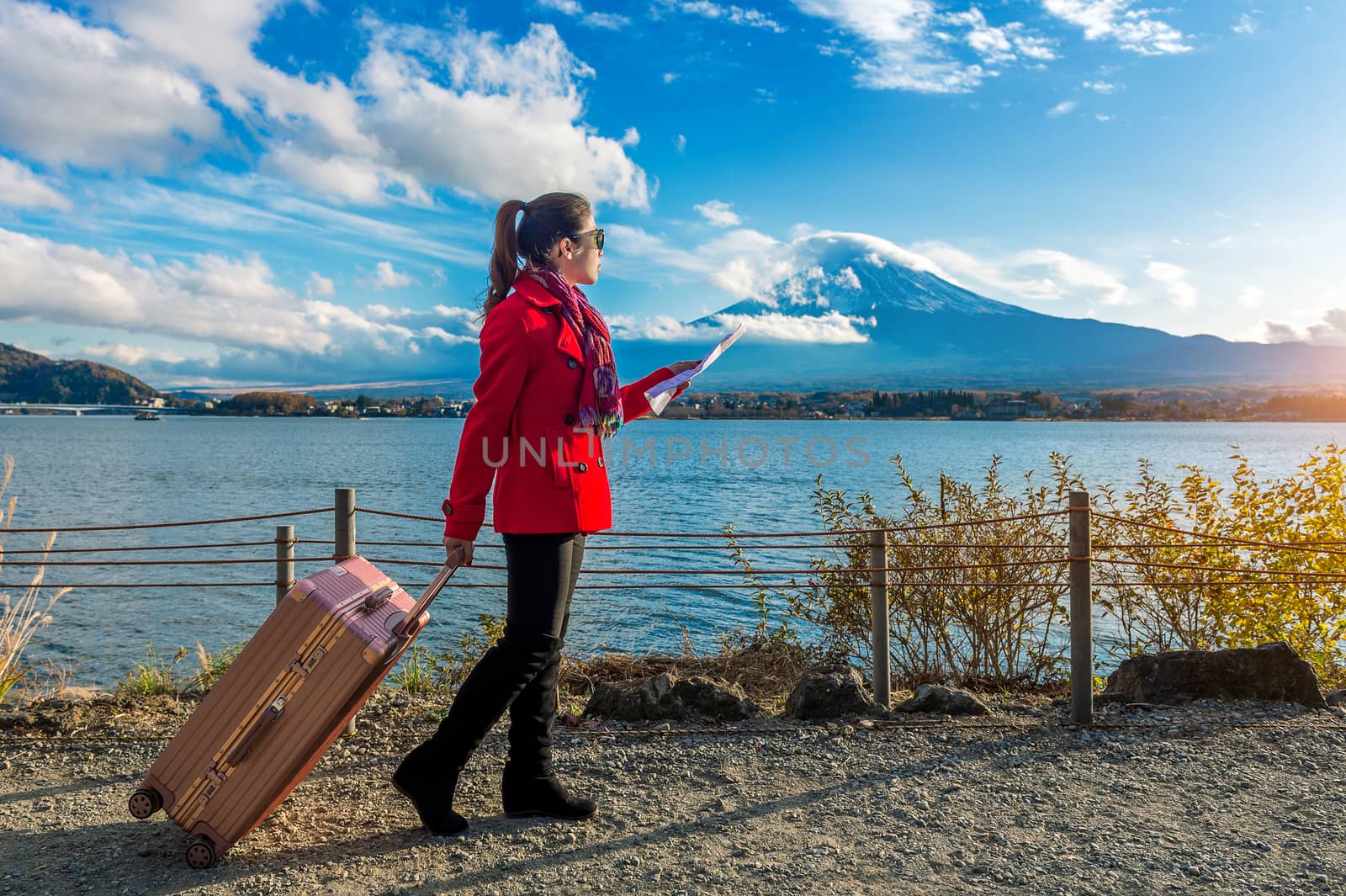 Tourist with baggage and map at Fuji mountain, Kawaguchiko in Japan.