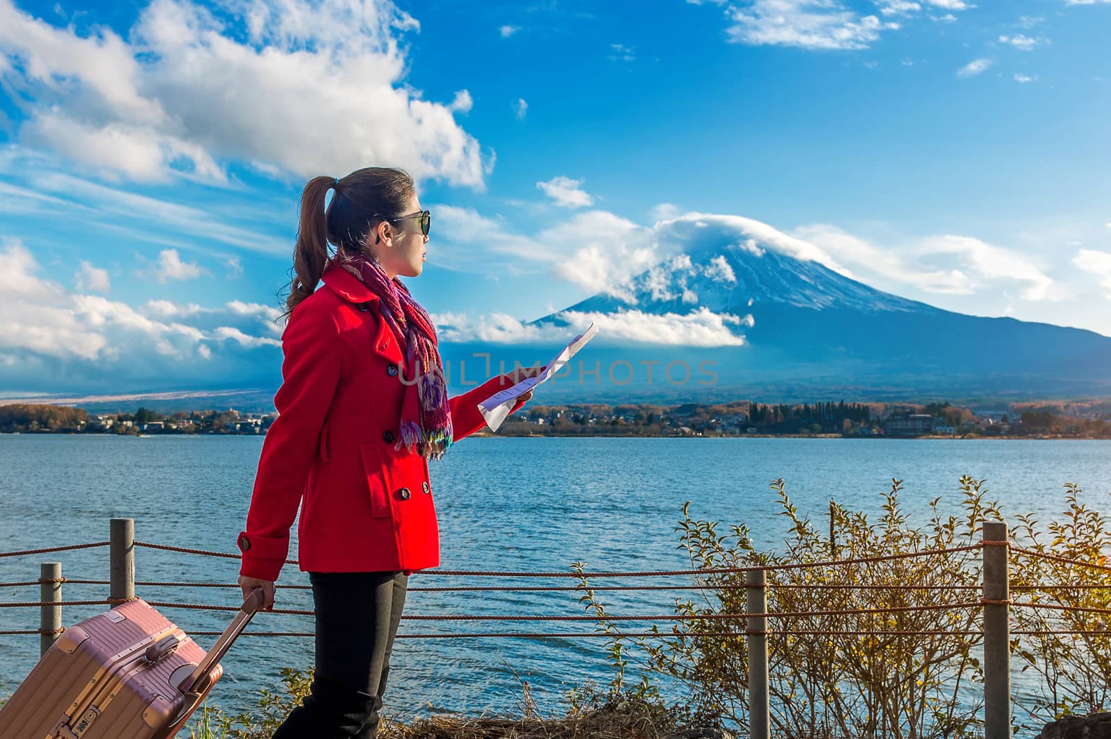 Tourist with baggage and map at Fuji mountain, Kawaguchiko in Japan. by gutarphotoghaphy