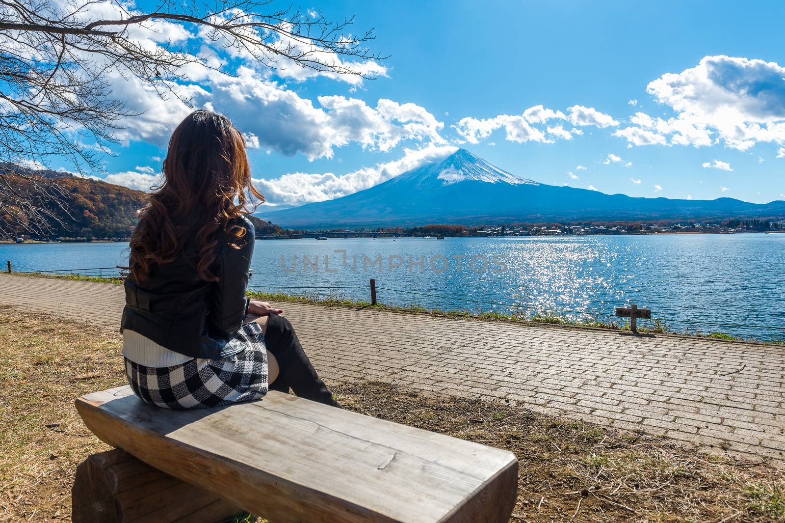 Woman looking to Fuji mountains at kawaguchiko lake, Japan.