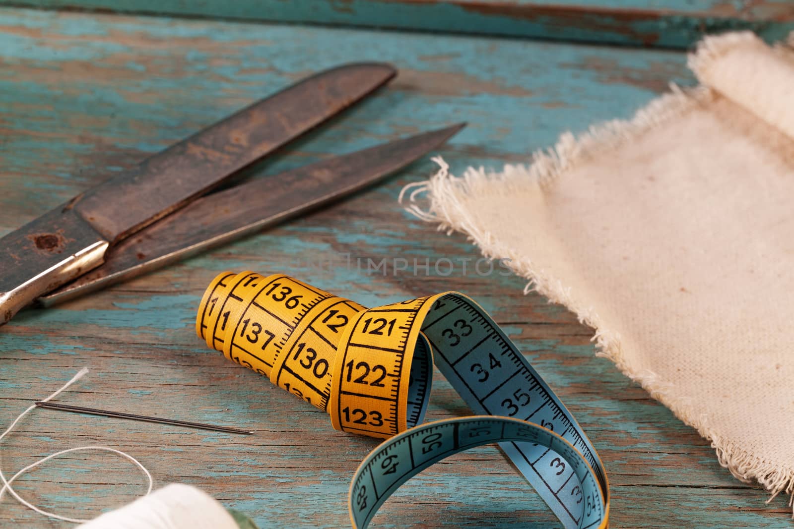 Retro sewing accessories on blue wooden background by igor_stramyk