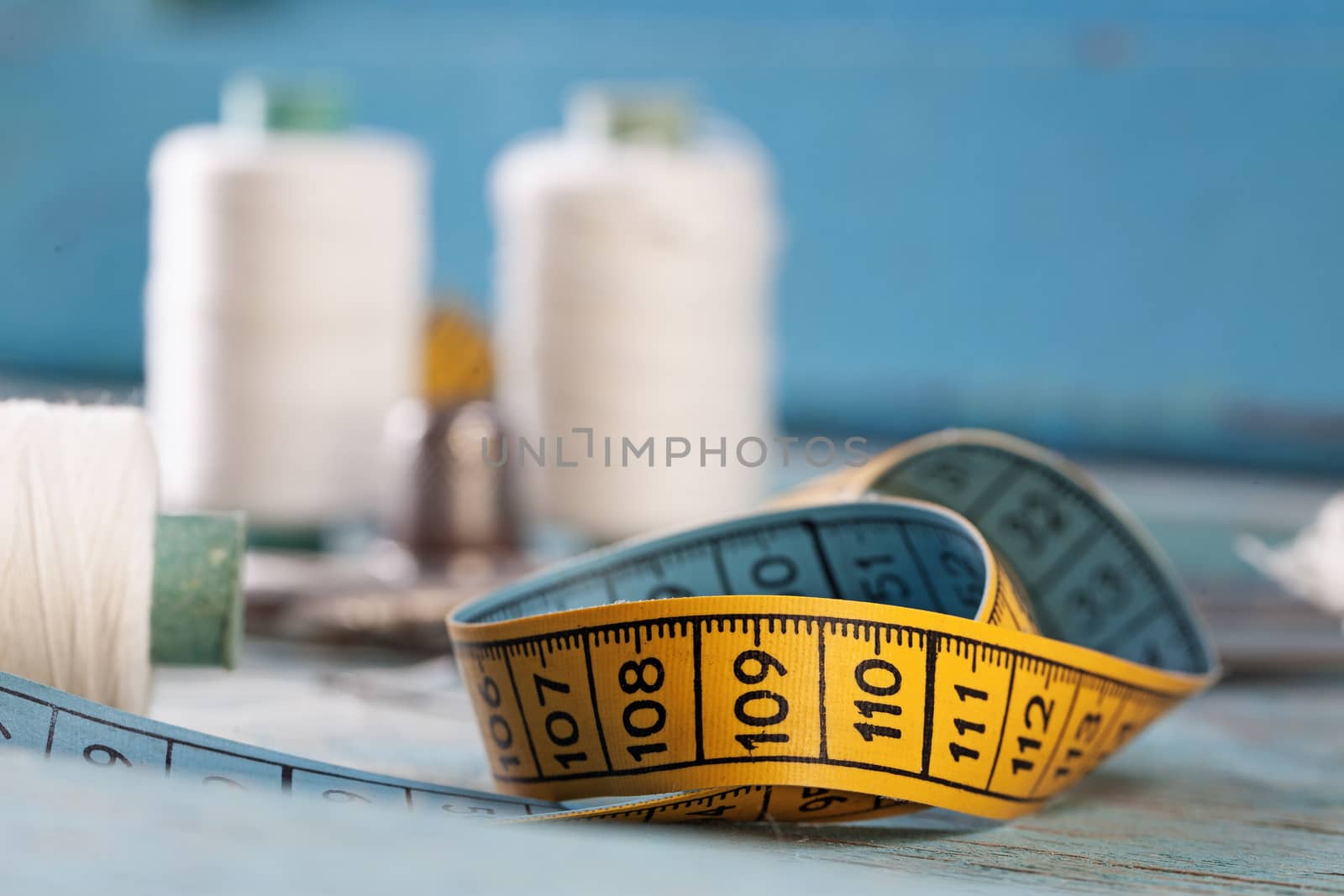 Retro sewing accessories on blue wooden background by igor_stramyk