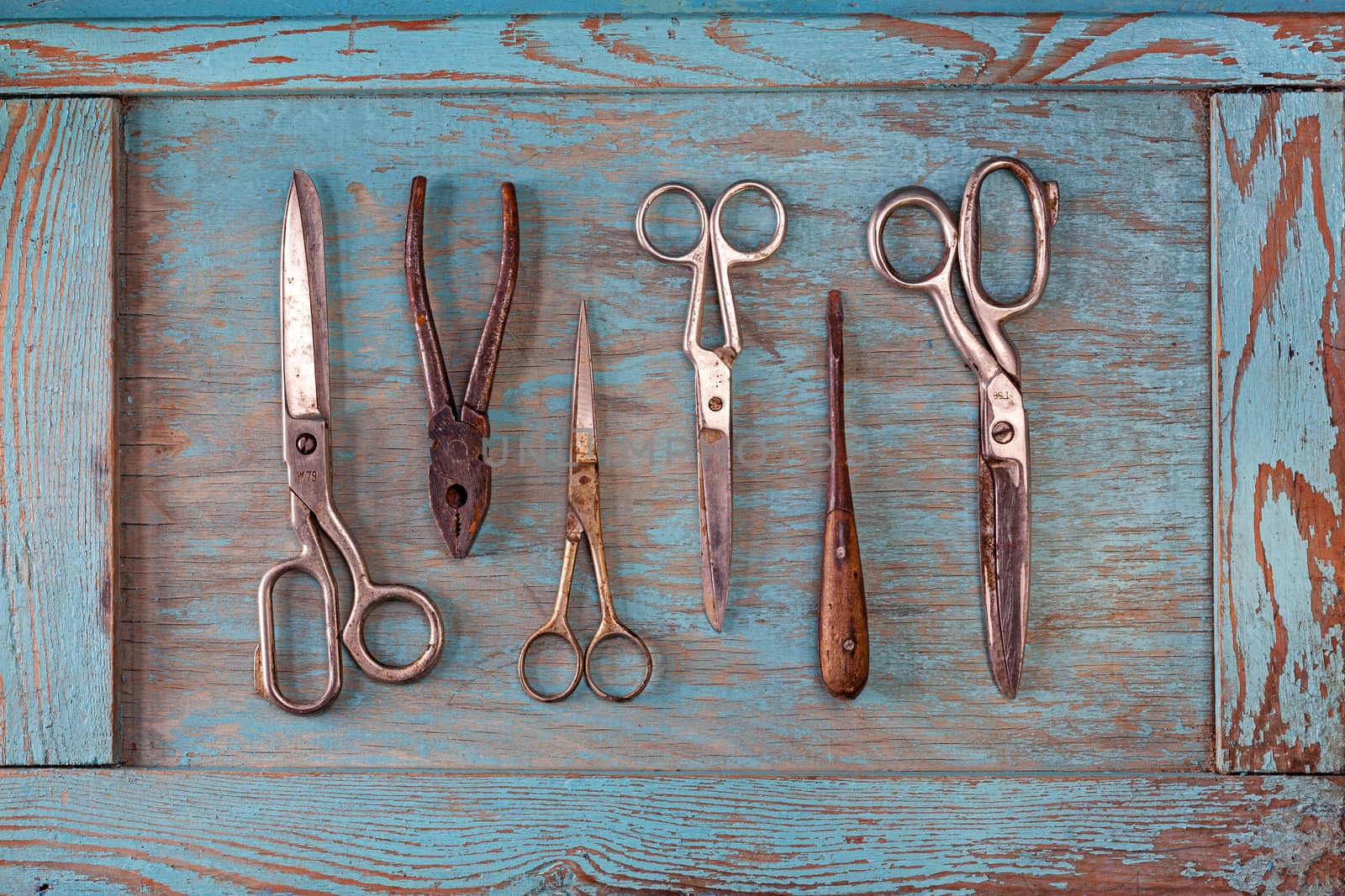 Collection of vintage tools on a blue wooden background by igor_stramyk