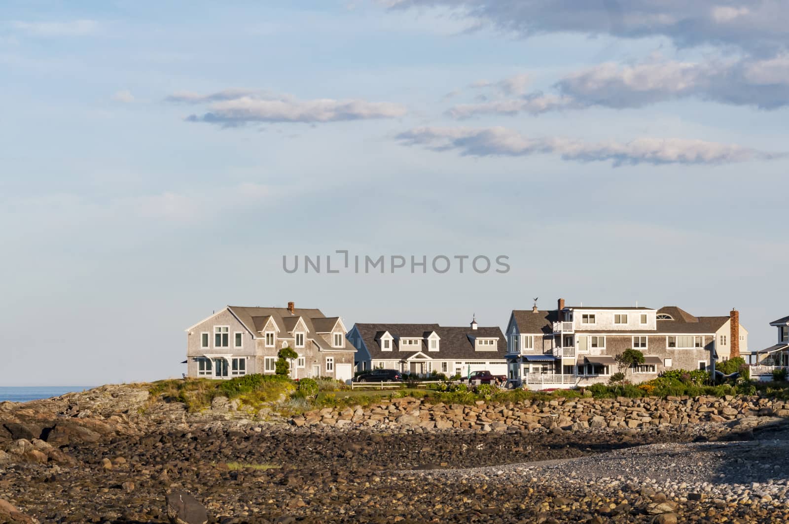 Houses near the coastline with blue and clean sky in Maine, USA