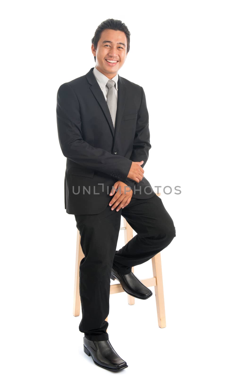 Asian businessman sitting on chair by szefei