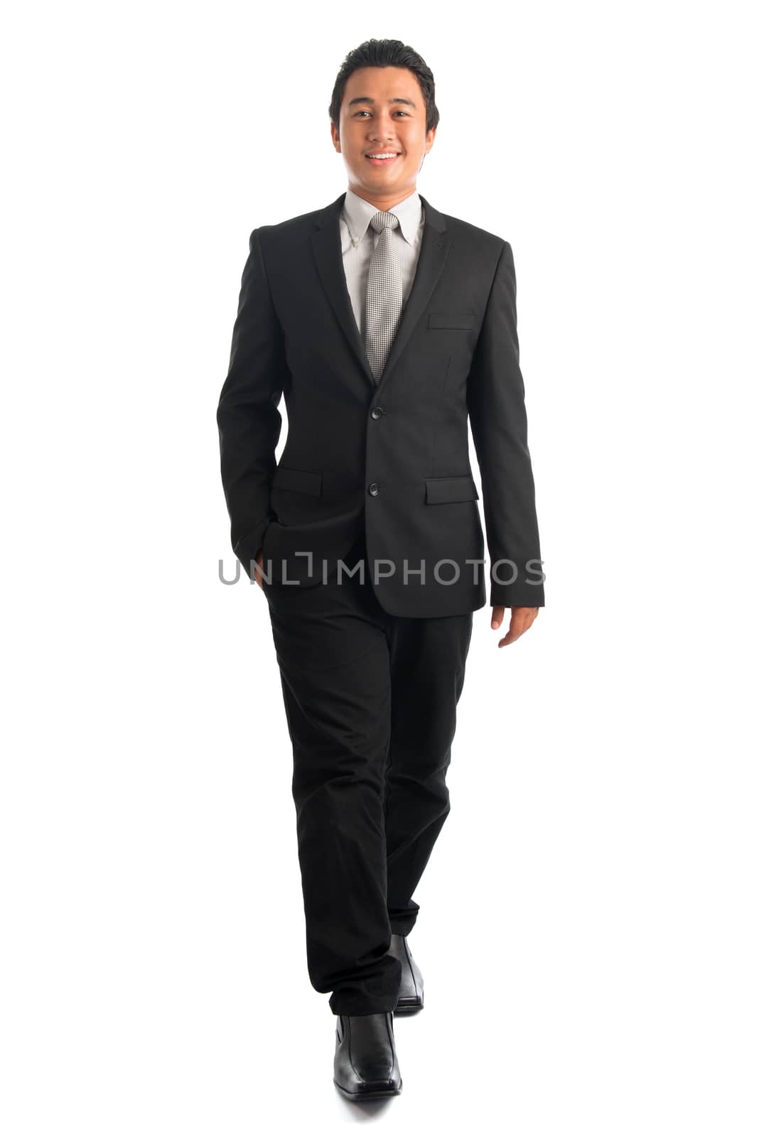 Full body attractive young Southeast Asian businessman walking, isolated on white background. Asian malay male model.