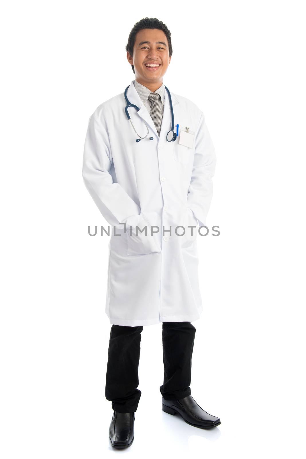 Full length front view attractive young male Southeast Asian medical doctor standing isolated on white background.