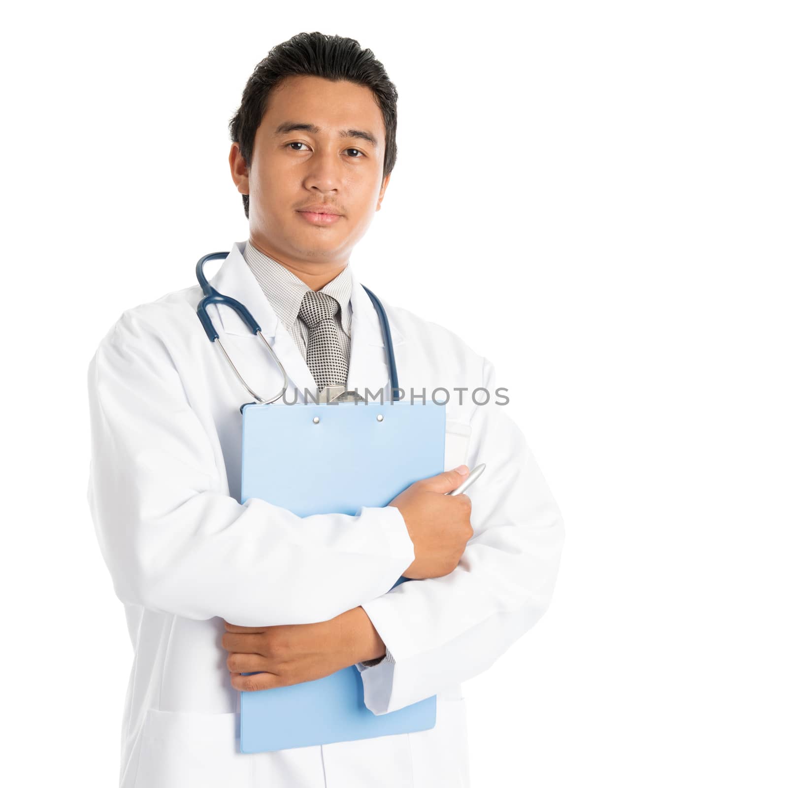 Portrait of attractive young male Southeast Asian medical doctor holding clipboard standing isolated on white background.