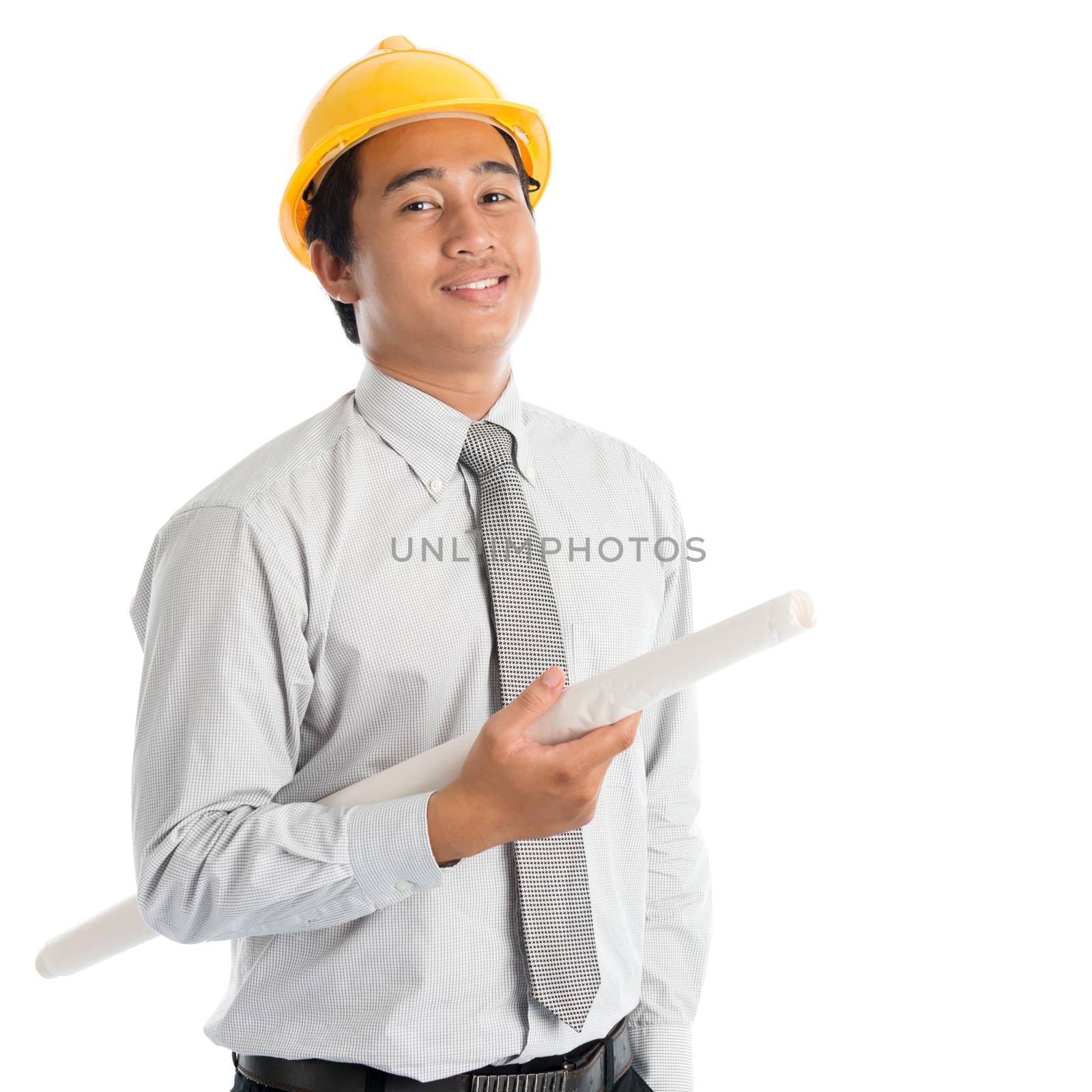 Portrait of attractive Southeast Asian engineer with yellow hard hat and blue prints smiling, standing isolated on white background.