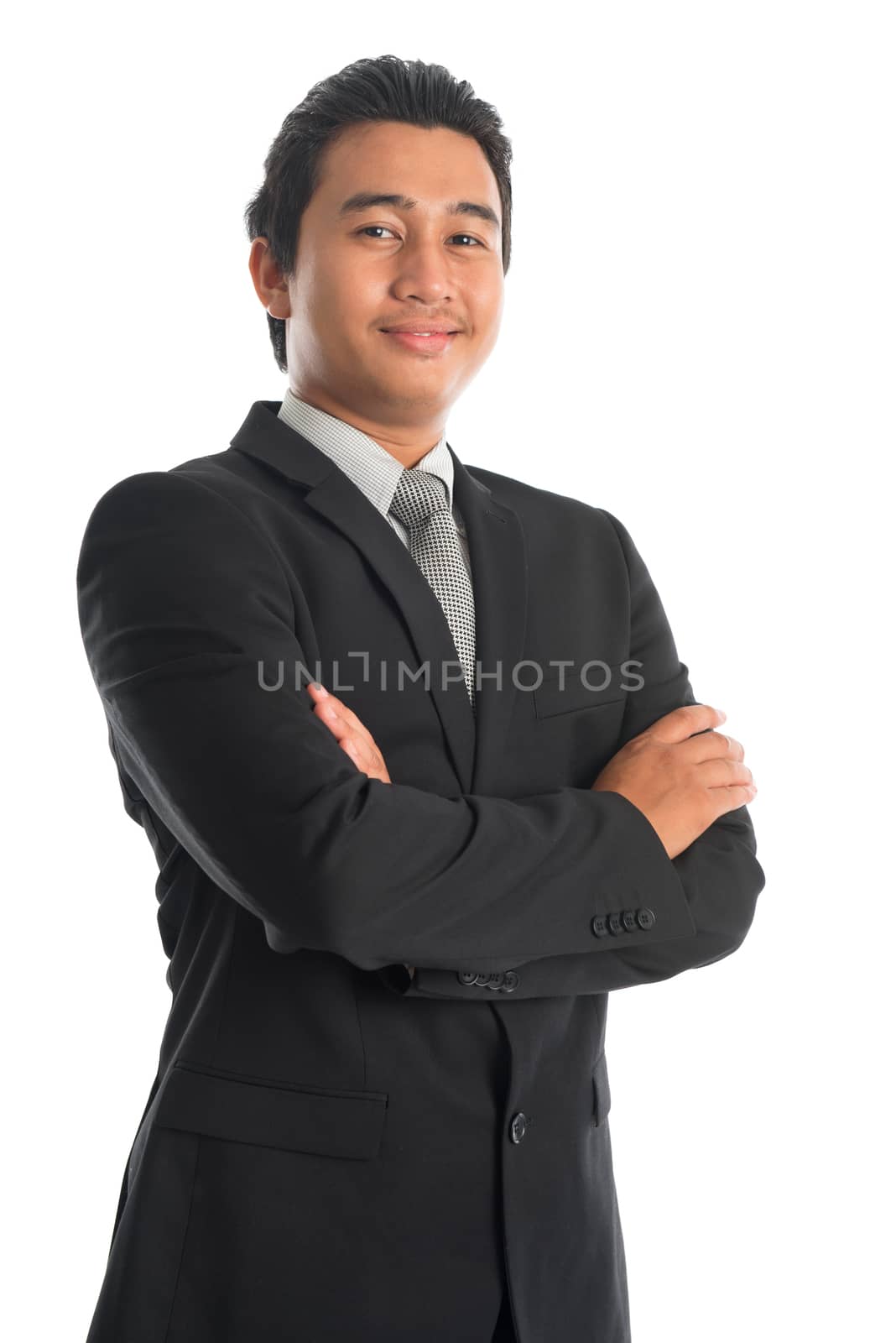 Portrait of attractive young Southeast Asian businessman arms crossed standing isolated on white background. Asian Malay male model.